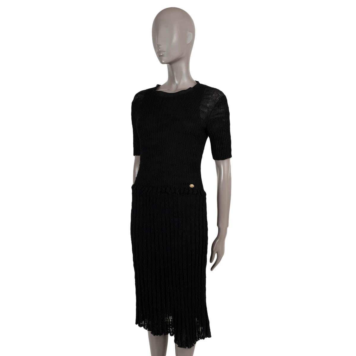 100% authentic Chanel semi-sheer knit midi dress in black textured rib-knit alpaca (48%), nylon (32%) and linen (20%). Features a round neck, short sleeves and drop waist with gold-tone button. Comes with silk slip dress. Has been worn and is in