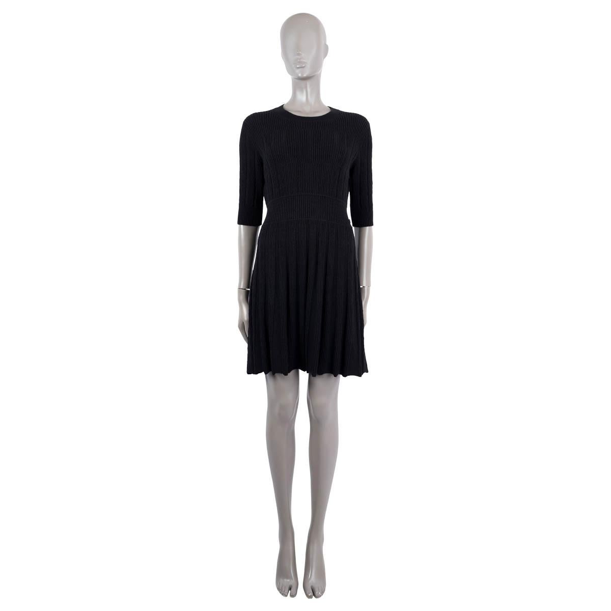 100% authentic Chanel textured flared rib-knit dress in black alpaca (67%) and wool (33%). Featuring short sleeves and waist band with logo button. Unlined. Has been worn and is in excellent condition.

2018