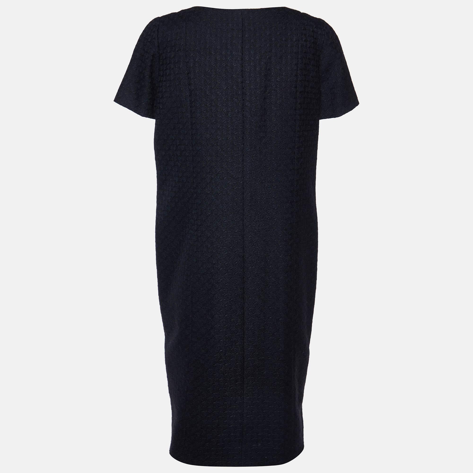 Crafted with precision, the Chanel dress exudes timeless refinement. Its sleek silhouette effortlessly contours the body, while the blend of alpaca and wool offers luxurious warmth. With understated elegance, it embodies sophistication for any