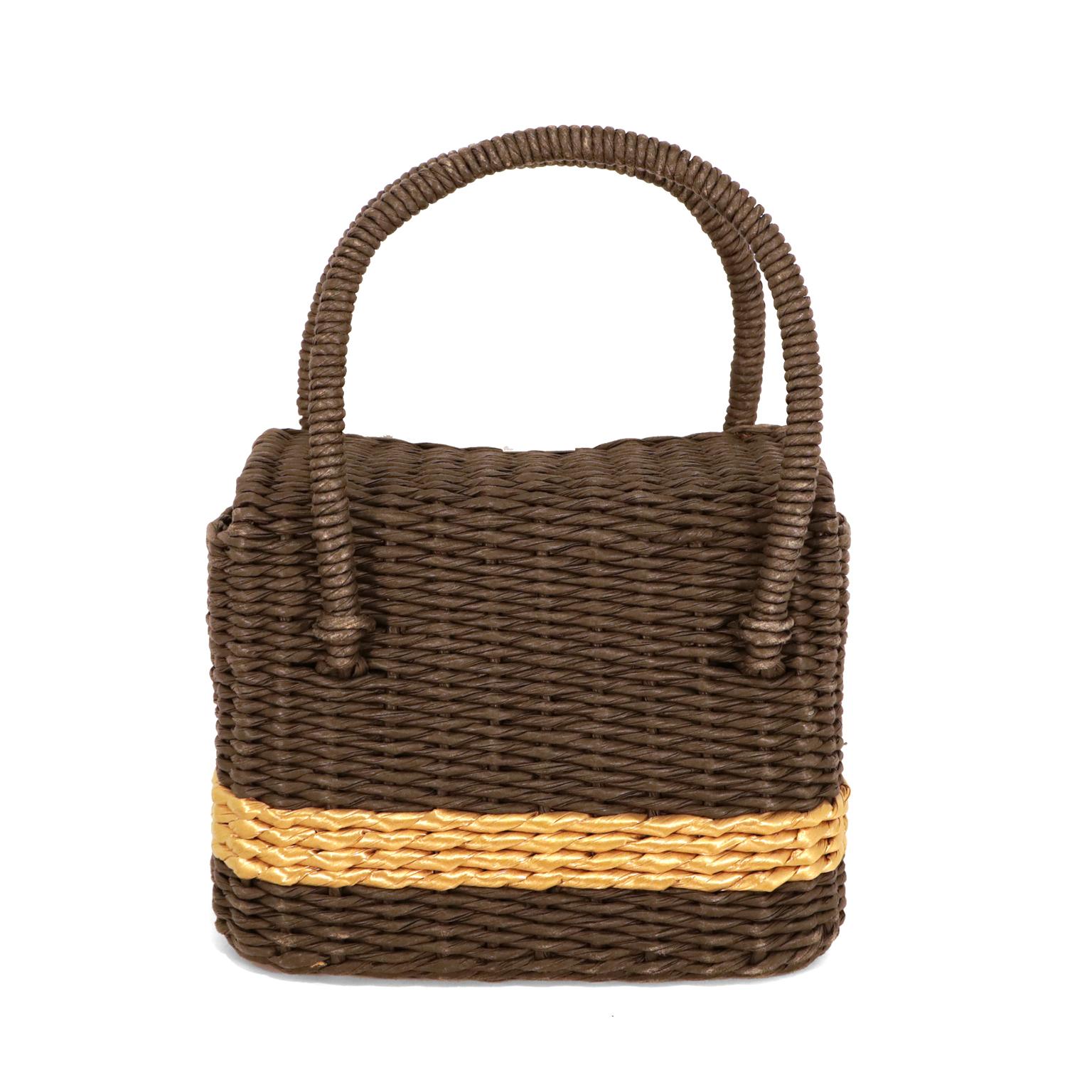 This authentic Chanel Black and Gold Wicker Basket Bag is in excellent condition.  Highly collectible and sought after, this is a rare piece for any collection.  
Black wicker sturdy woven bag has golden banded stripe.  Matte silver tone hardware