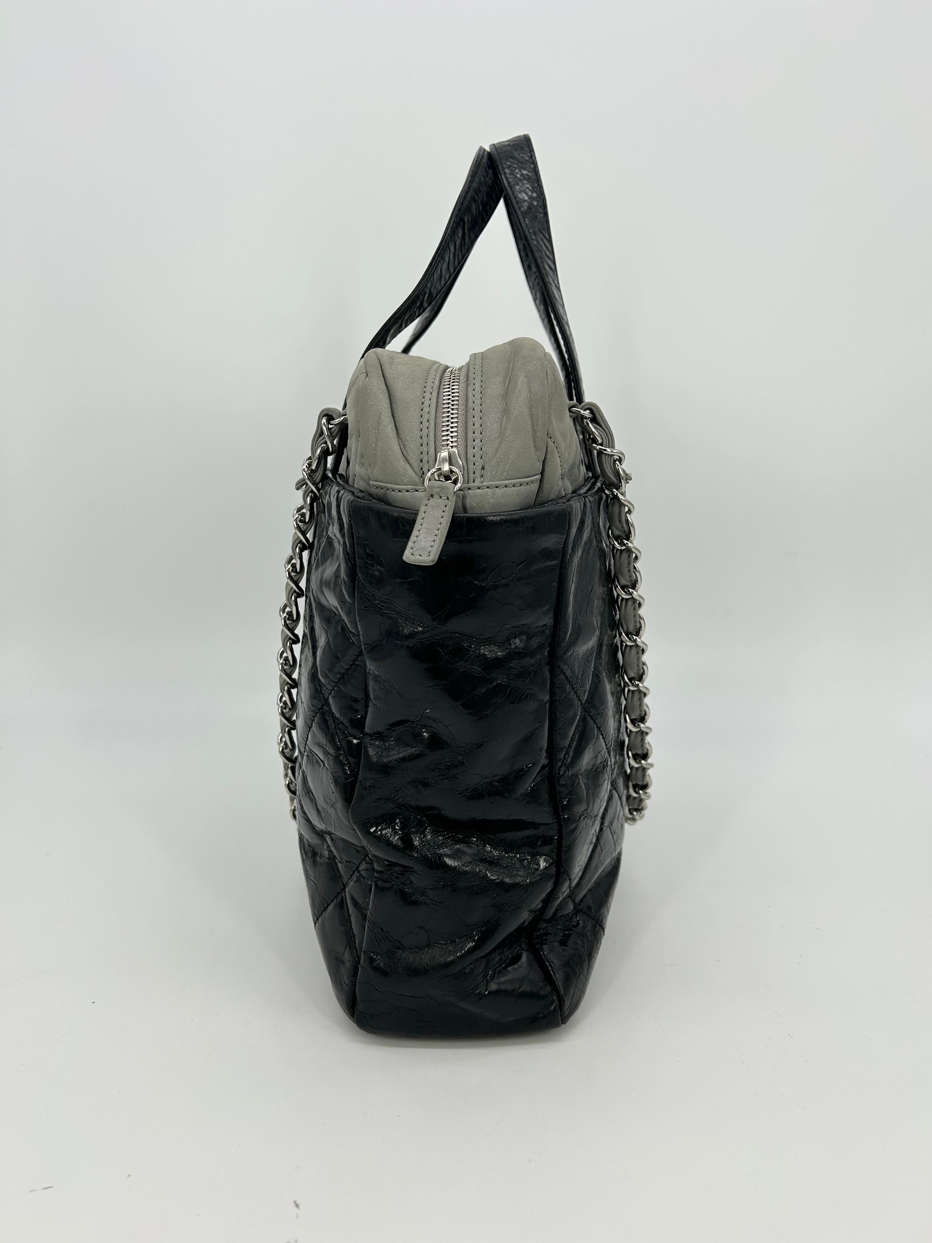 Chanel Black and Grey Leather Portobello Tote in very good condition. Distressed quilted black leather with grey shimmery soft calfskin leather top trimmed with double handles and woven chain and leather shoulder straps. Silver hardware trim and CC