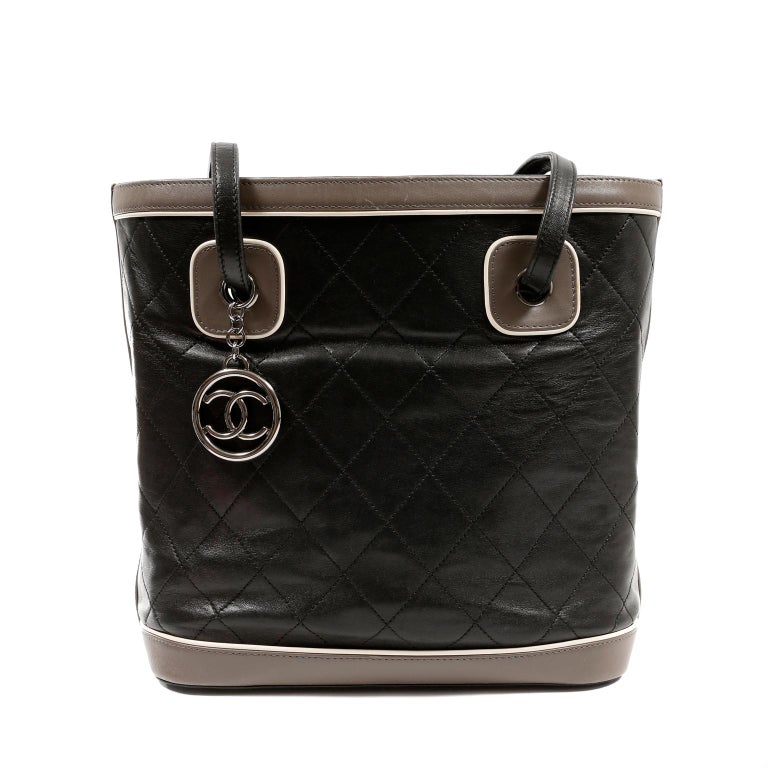 This authentic Chanel Black Quilted Leather Bucket Tote is in excellent condition.  Simply designed, this classic piece is perfect for daily enjoyment. 
Black leather is quilted in signature Chanel diamond pattern.  Grey contrasting leather accents