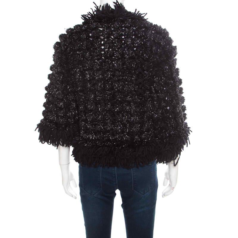 Chanel combines a feminine aesthetics and refined fashion in this glamorous black jacket. It belongs to the brand's Autumn-Winter 2009 collection. The beguiling crochet knitting and fringe details accentuate the cropped silhouette. The open front