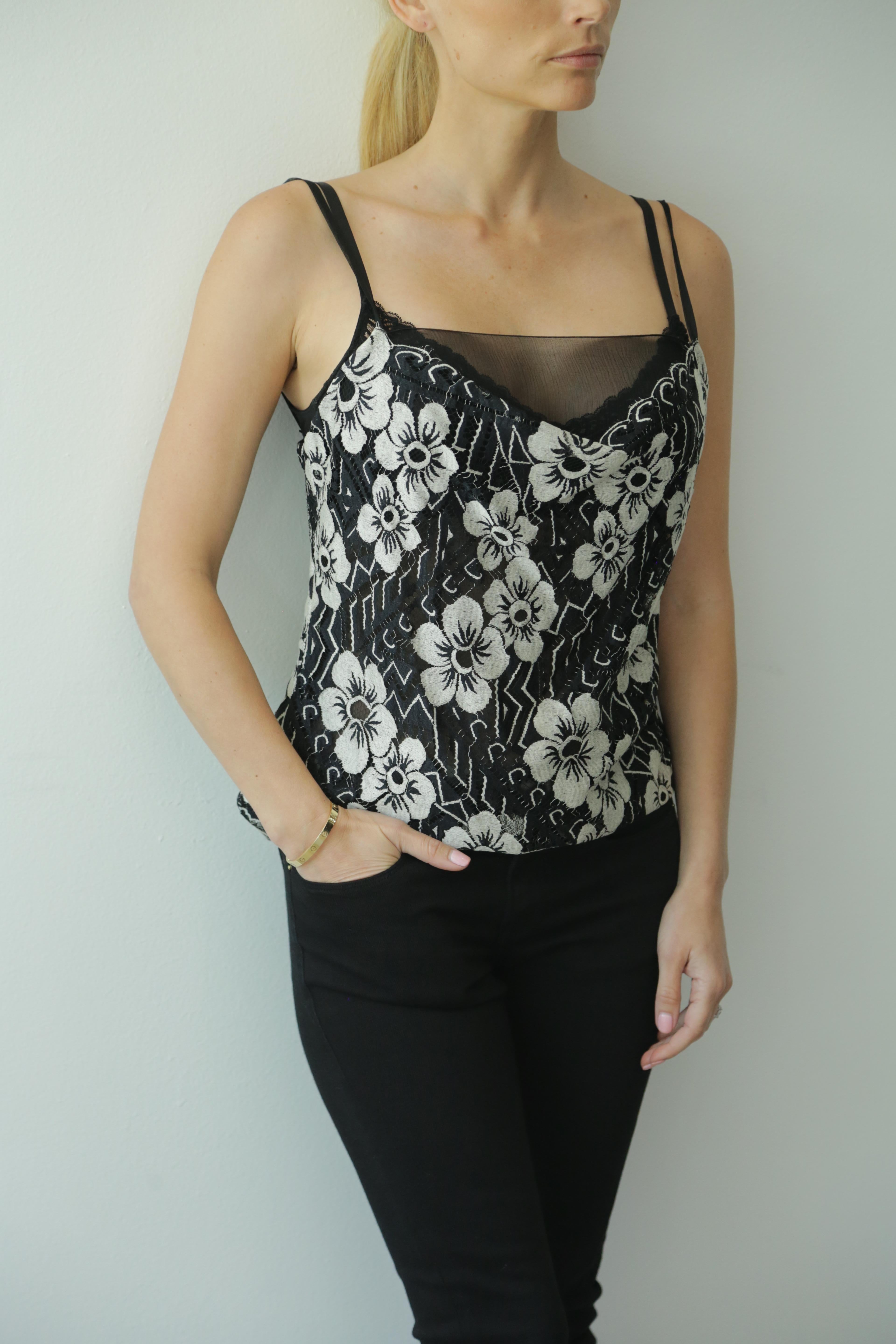 Chanel black and white floral lace camisole. 
Backside Chanel logo buttons.
A Beautiful camisole to be worn by itself of under a blazer or cardigan. 

67% polyamide nylon, 33% cotton. Lining 100% silk.

Mint Condition. 
Size 40 (fits smaller) (like