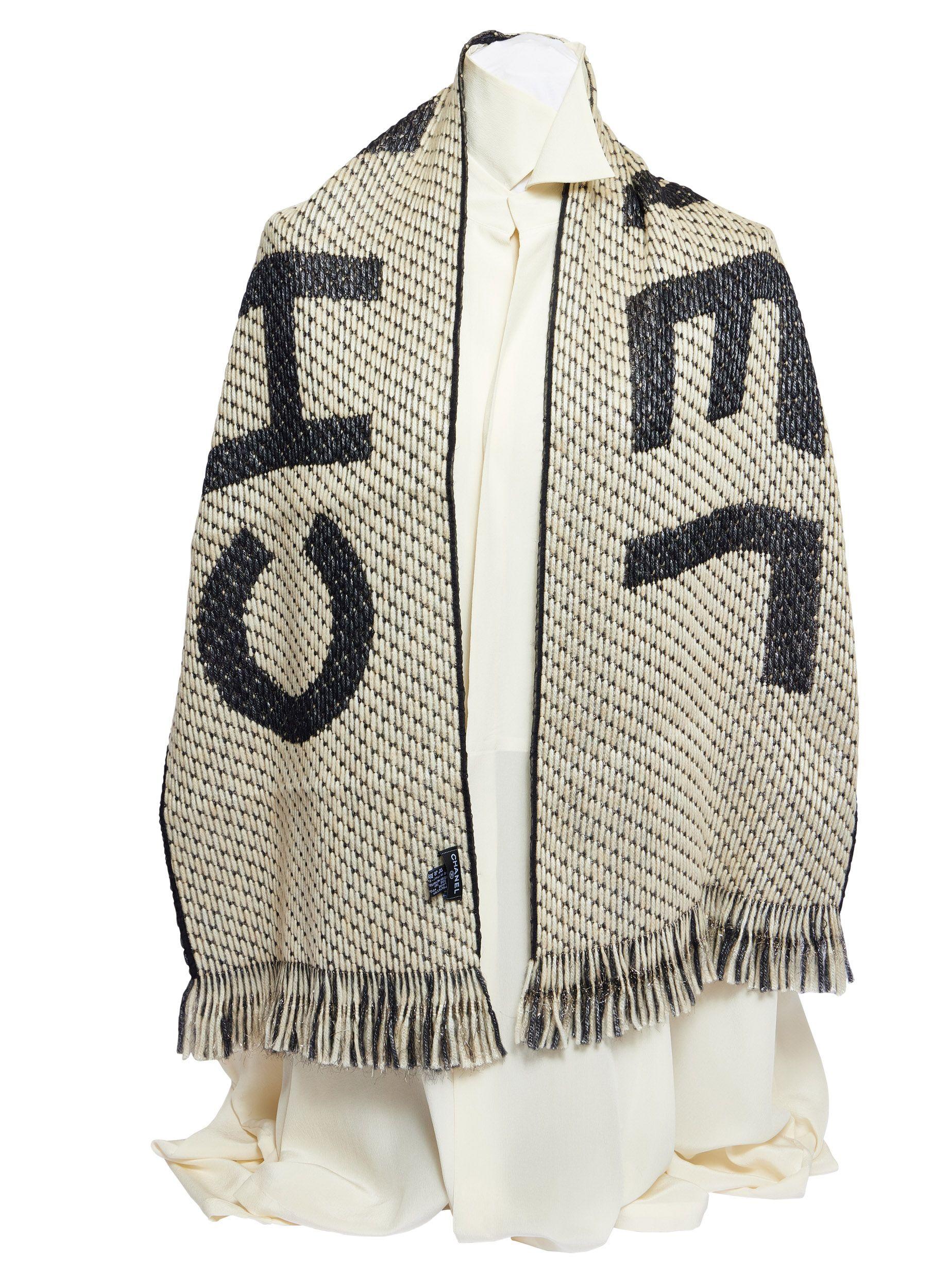 Brand new Chanel scarf in black and white. The material lurex gives the piece a metallic look so you can either wear it at daytime as well as in the evening. Chanel is written over the whole scarf and you can wear it both sides. Either black or