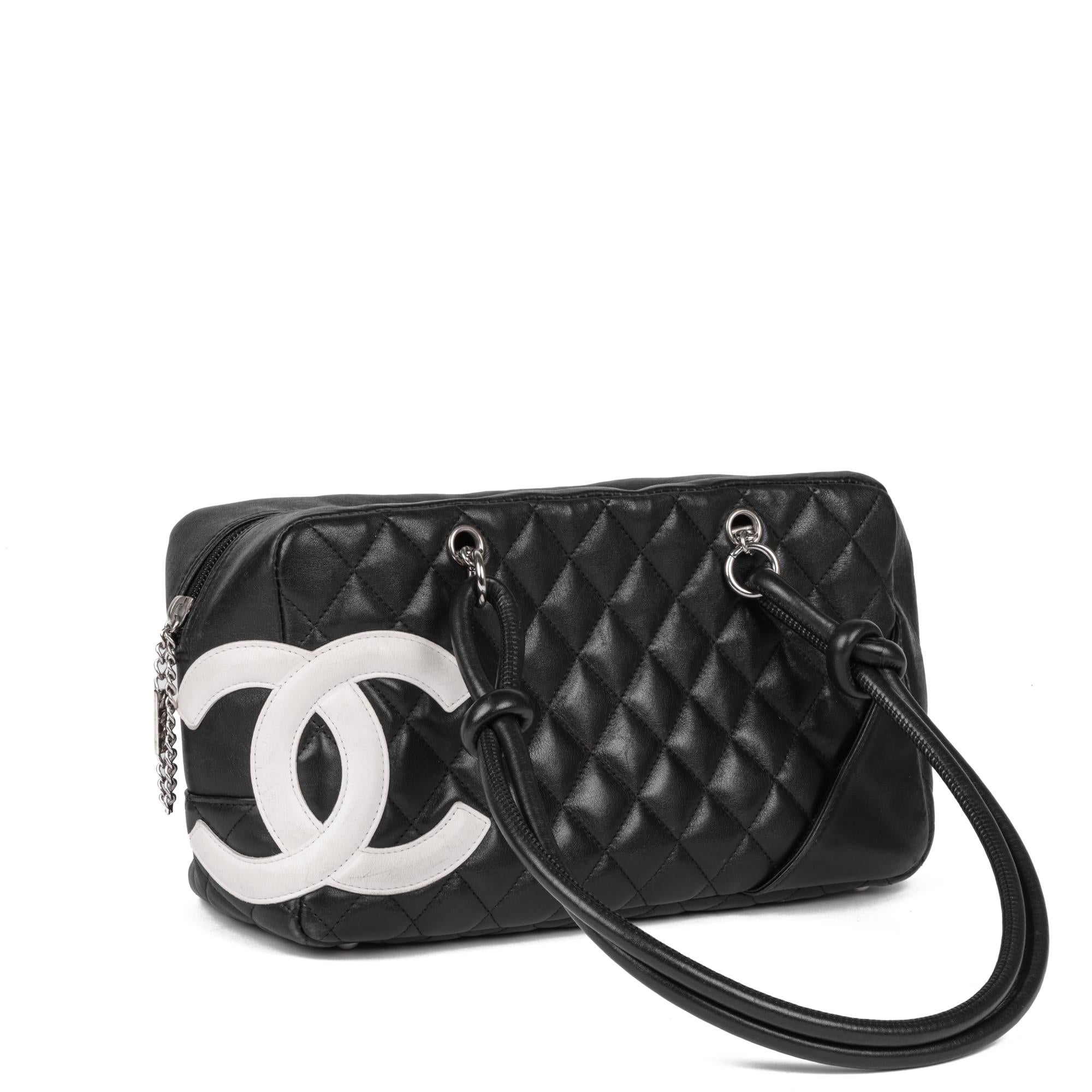 CHANEL
Black and White Quilted Lambskin Large Cambon Bowling Bag

Serial Number: 10391492
Age (Circa): 2005
Accompanied By: Chanel Care Booklet, Authenticity Card
Authenticity Details: Authenticity Card, Serial Sticker (Made in France)
Gender: