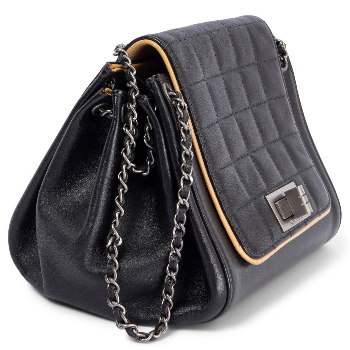 100% authentic Chanel small accordion handbag in black calfskin with beige pipping and light gunmetal hardware. Opens with a classic turn-lock and is lined in beige smooth lambskin with one open pocket against the back. Has been carried and is in