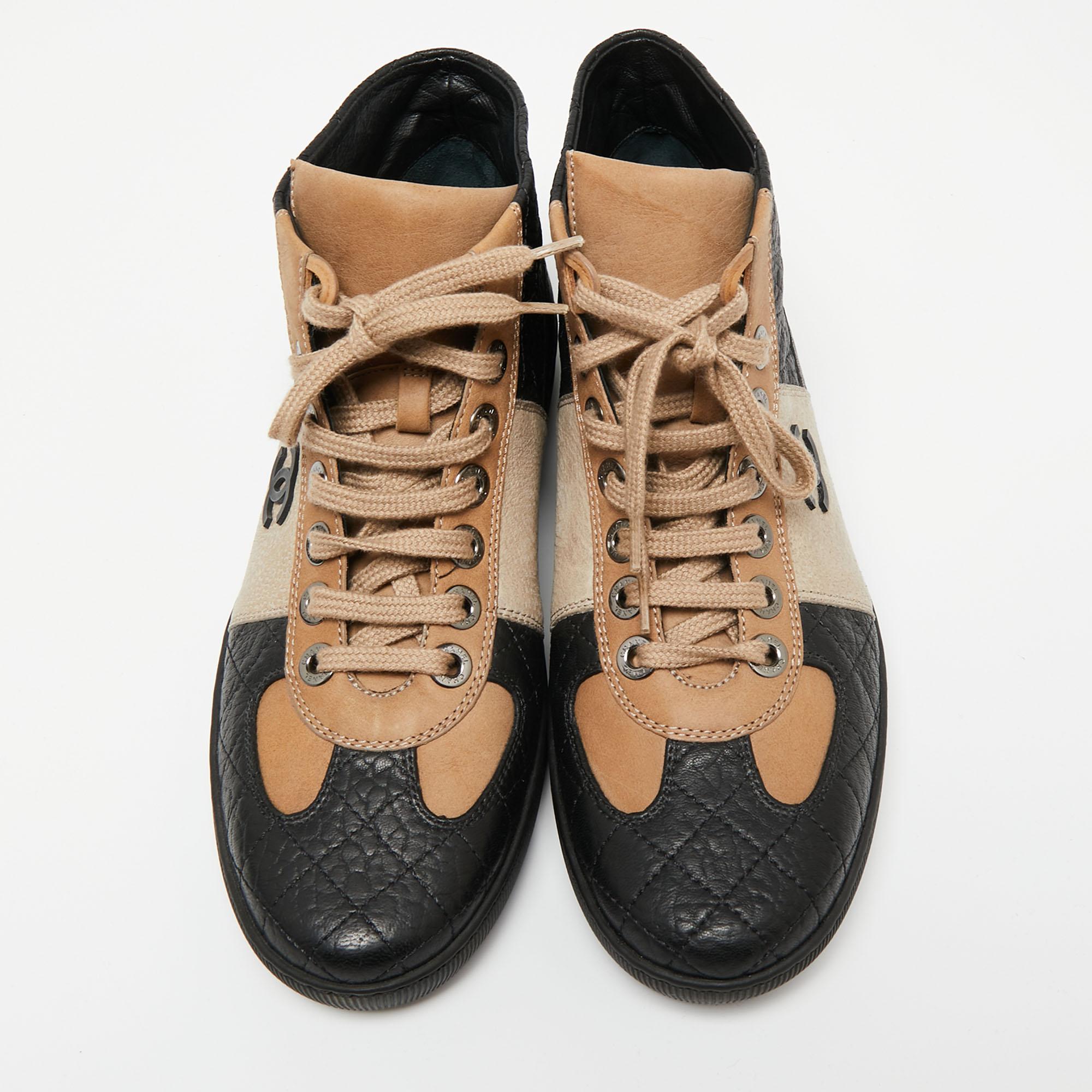Complement your casual look with these high-top sneakers from the house of Chanel! Crafted from beige and black leather, these sneakers have simple lace-ups and notable elements like the CC logo and diamond quilt.

Includes: Original Dustbag