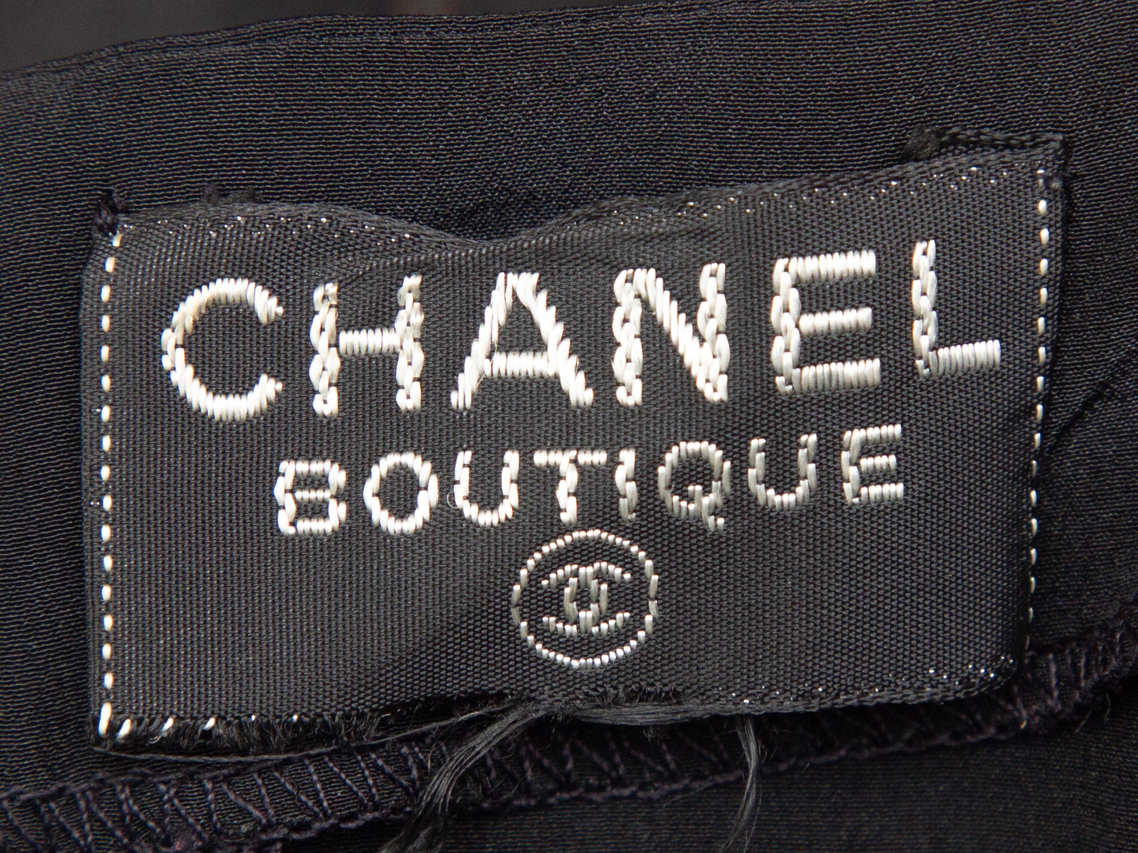 Product details: Vintage black silk camisole by Chanel Boutique. V-neck. Narrow straps. Zip closure at back. 30