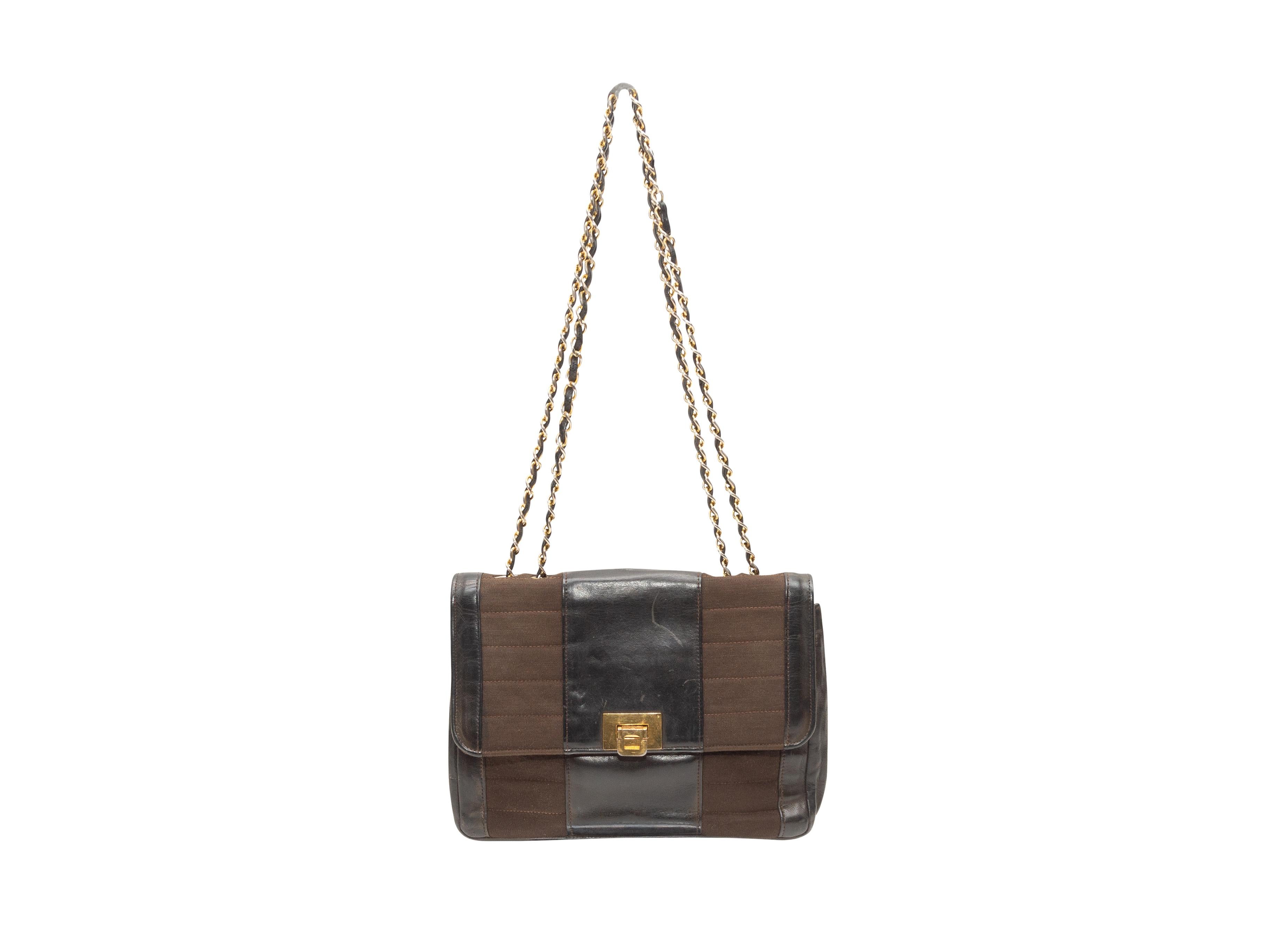 Product Details: Vintage Black & Brown Chanel 50s/60s Handbag. This handbag features a leather and brown textile body, gold-tone hardware, dual chain-link and leather shoulder straps, and a front clasp closure. 10