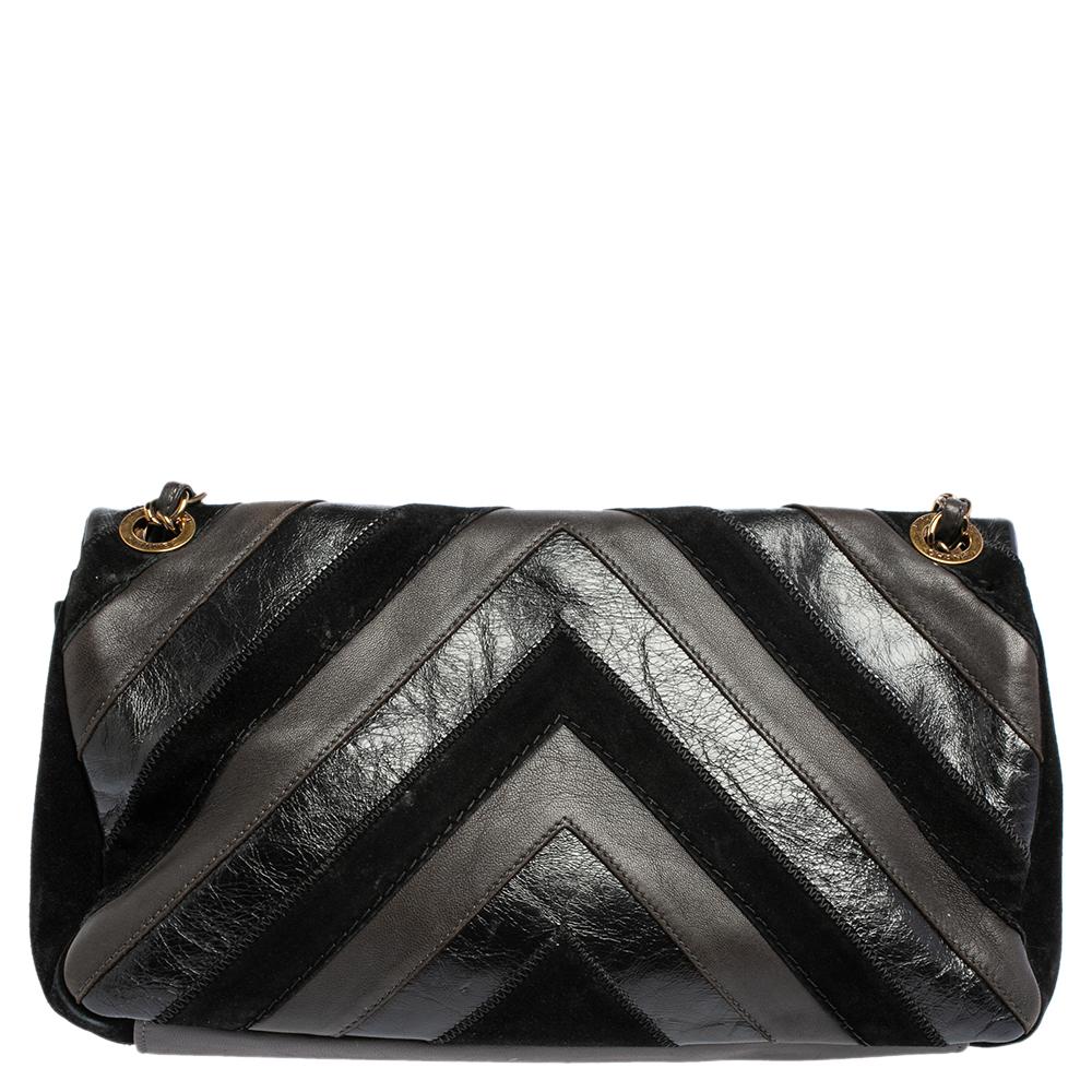 We are in utter awe of this flap bag from Chanel as it is appealing in a surreal way. Exquisitely crafted from leather and suede with a lovely striped pattern, it bears the signature label on the fabric interior and the iconic CC turn-lock on the