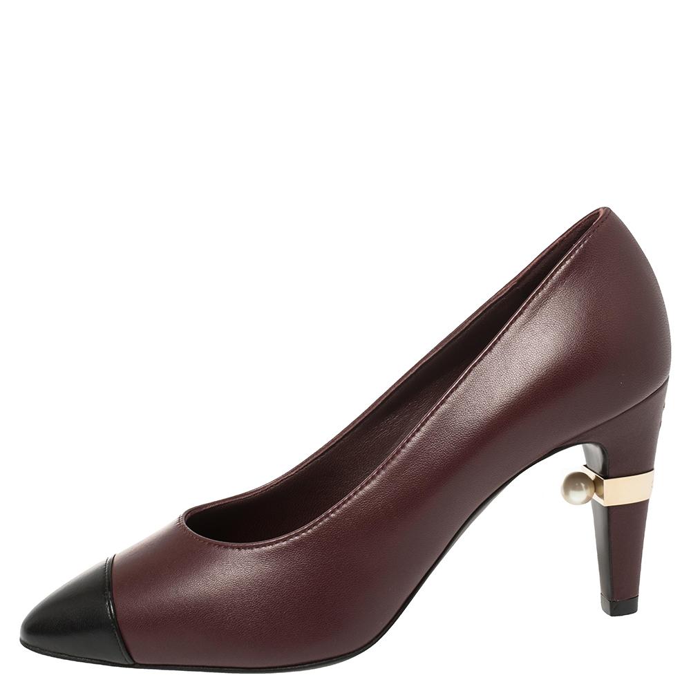 How can one not be smitten by these stunning pumps by Chanel! In a magical blend of luxury and high-fashion, the pumps come crafted from burgundy leather and designed with almond black cap toes and the CC faux pearls on the heels add the perfect