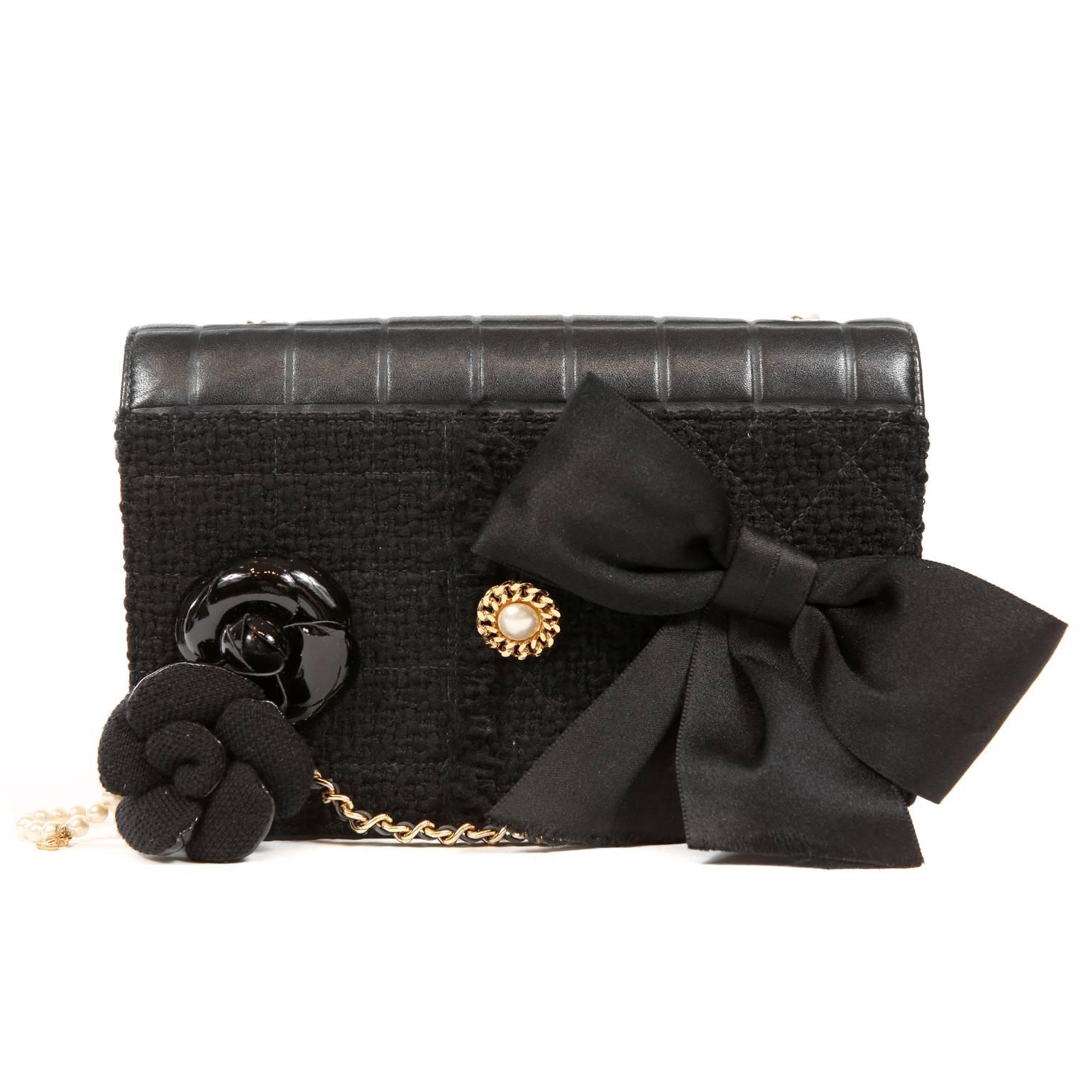 Chanel Black Buttons and Bows Flap Bag- Pristine Condition
 A rare and collectible special edition style, it combines fabrics, textures and accessories into one fabulous piece.
Black flap bag has tweed fabric front with camellia flower pins, pearl