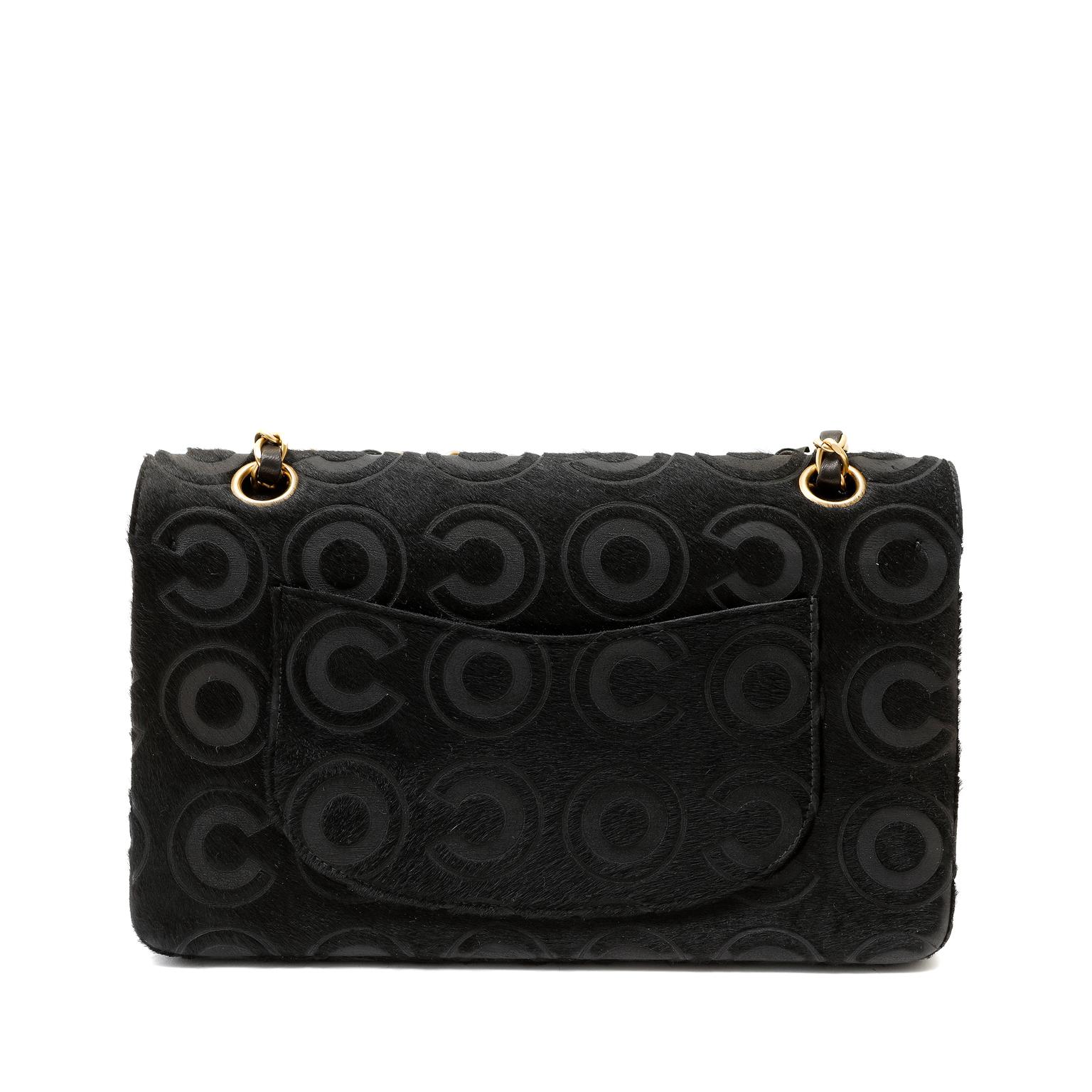 This authentic Chanel Black Calf Hair COCO Double Flap Bag is in pristine condition.  Perfectly scaled in the medium silhouette, this unique take on the double flap is a beautiful addition to any collection. 
Black calf hair with tonal COCO