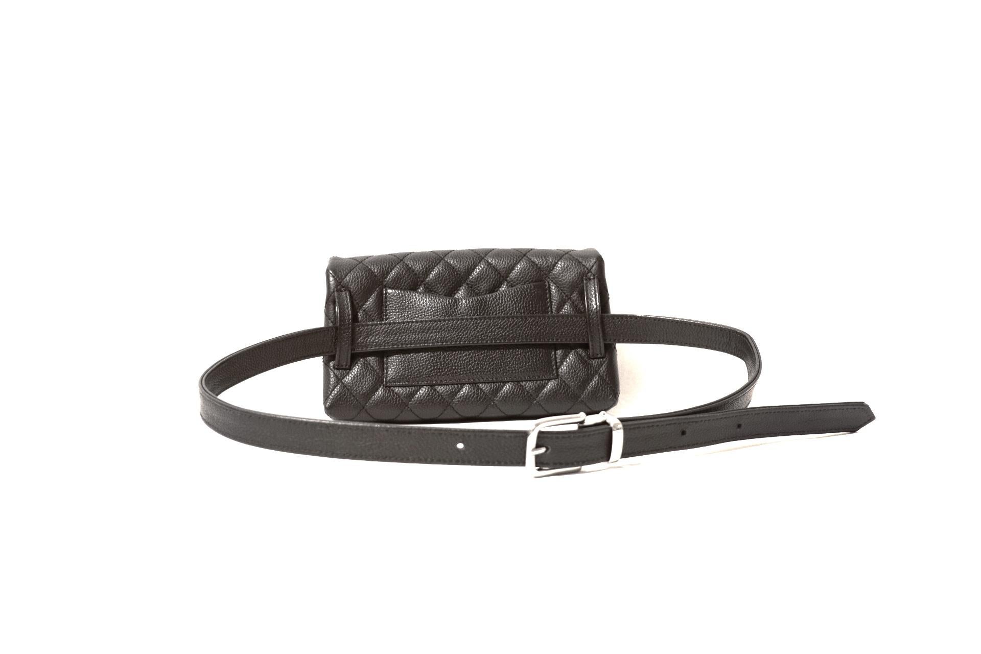 This authentic Chanel Black Quilted  Calfskin Uniform Waist Bag is in pristine condition. The very desirable style carries just the essentials and can be carried in a variety of ways.  
Black textured calfskin is quilted in signature Chanel diamond