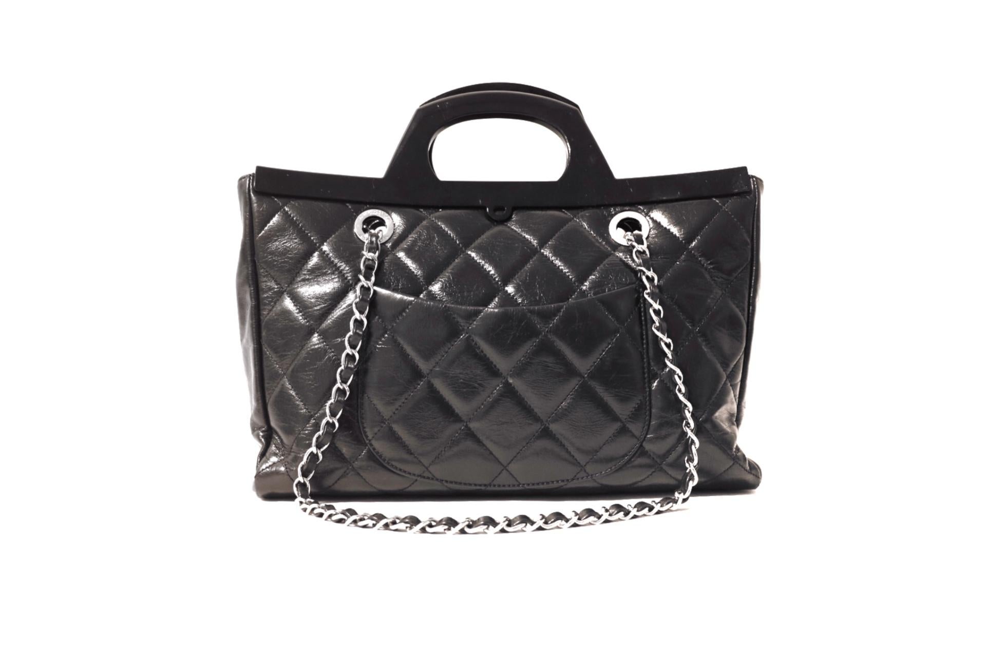 This authentic Chanel Black Calfskin CC Delivery Tote is in excellent plus condition.  From the 2014 collection, the sophisticated CC Delivery Tote allows for top handle or shoulder strap carry.  
Clack glazed calfskin is quilted in signature Chanel