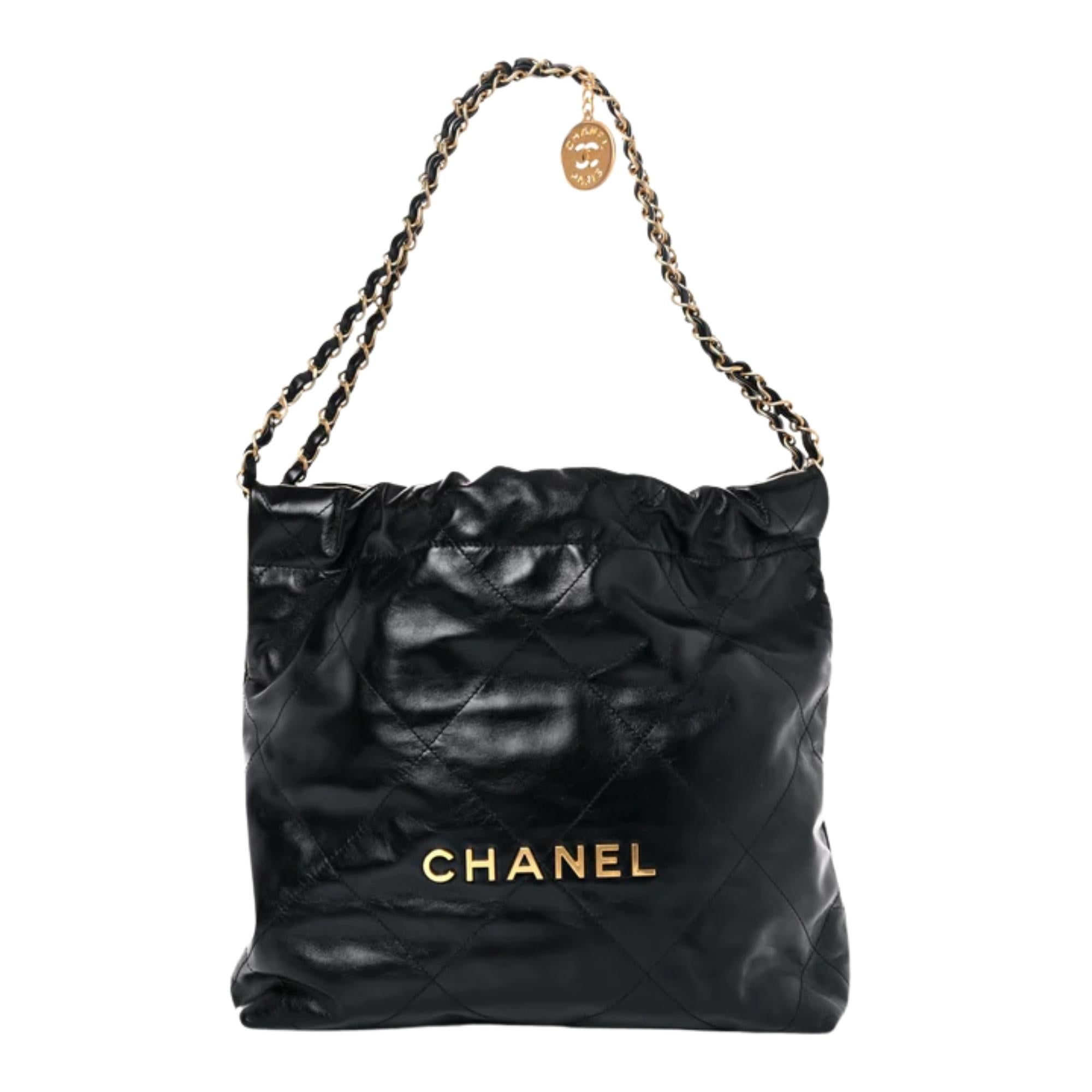 This bag is made of diamond-stitched calfskin leather in black with gold tone hardware. The bag features leather threaded brass chain shoulder straps, a matching Chanel logo on the front and a hanging logo charm. The drawstring shoulder straps and