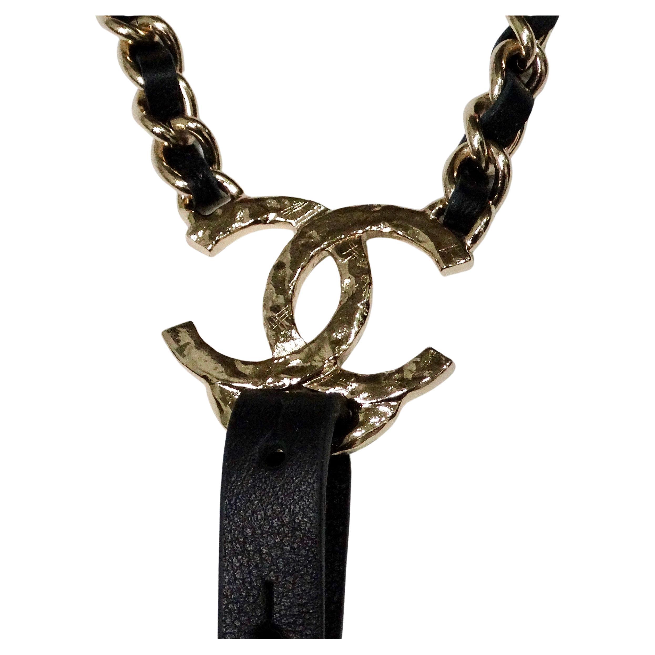 The Chanel Black Calfskin Leather Gold-Tone Interlocking CC Chain Suspenders are a luxurious accessory that exudes timeless elegance and sophisticated craftsmanship. Crafted from high-quality black calfskin leather, these suspenders feature a