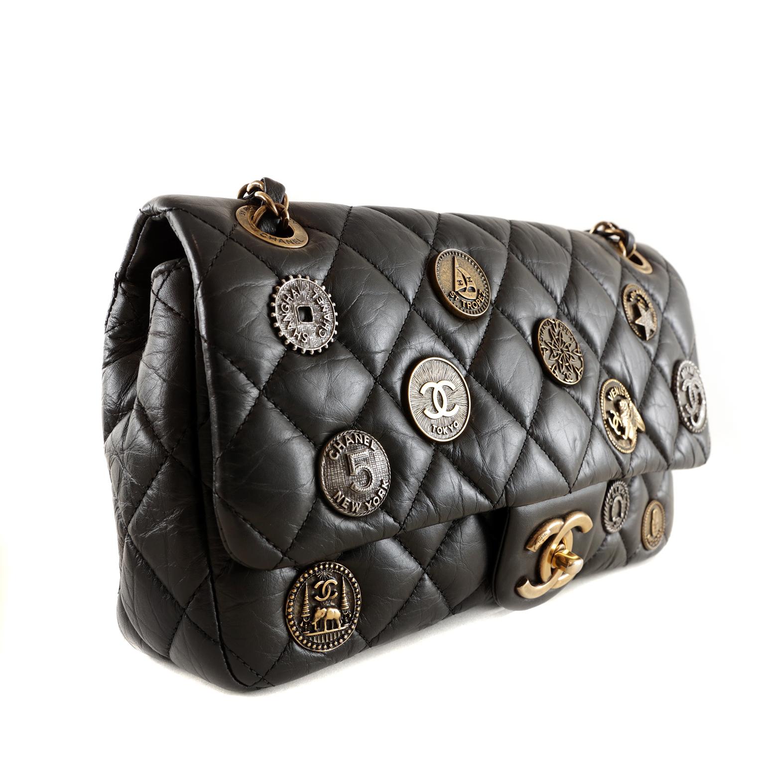 Chanel Black Calfskin Medallion Flap Bag - pristine condition, appearing never carried
 From the 2015 Cruise Collection. The edgy style features the Chanel classic silhouette embellished with multiple metallic medallions.    
Black aged calfskin is