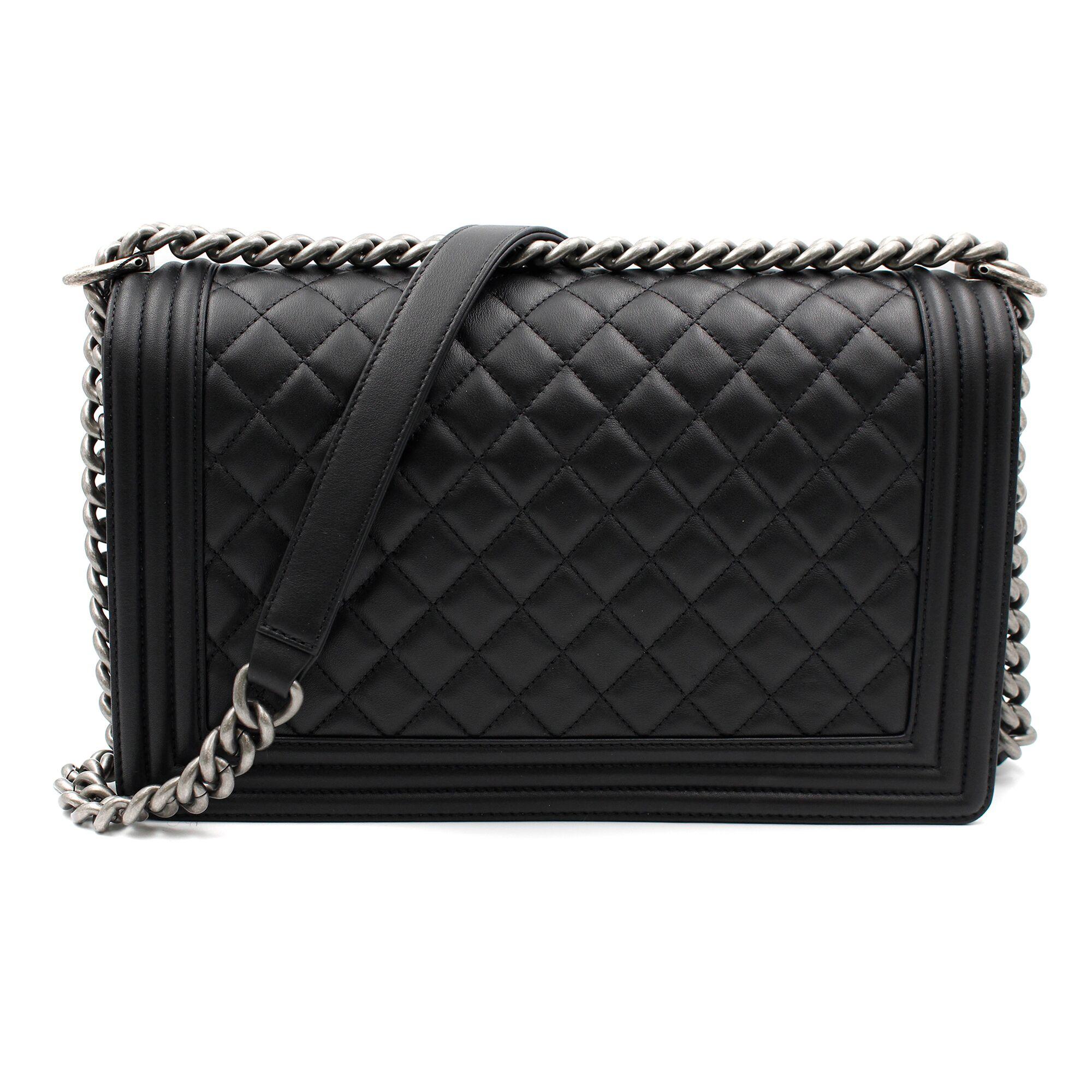 New Chanel Quilted Large Boy Flap Bag in black calfskin with ruthenium-finish hardware. This bag features a front flap with the Boy signature CC push lock closure and an adjustable interwoven ruthenium-finish chain link with black leather