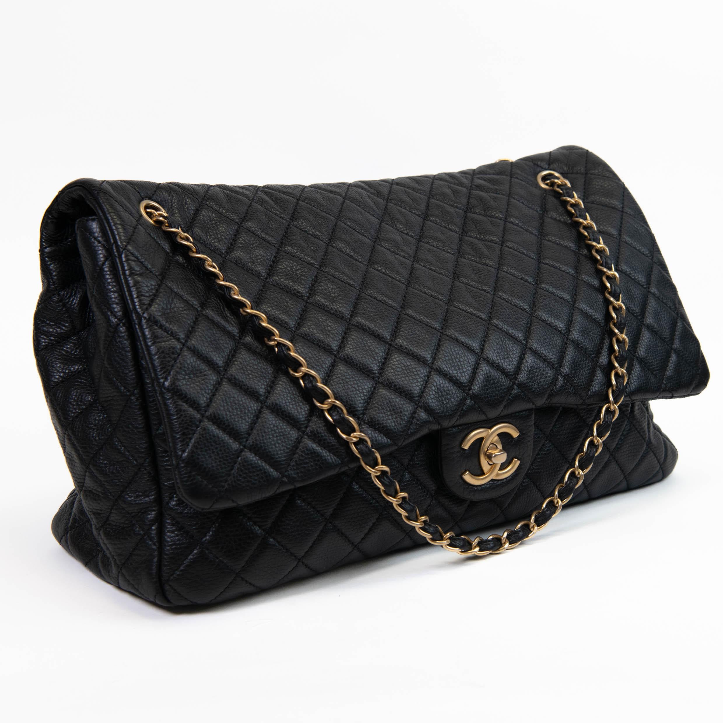 100% Authentic 

This chic oversized flap is crafted of black calfskin quilted leather in black. The shoulder bag features a rear patch pocket, a chain-link shoulder strap threaded with black leather and a leather shoulder pad. The CC turn lock