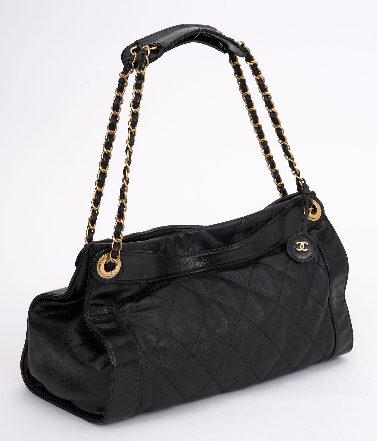 This Chanel Black Calfskin Shopper is a classic, this chic silhouette features black calfskin and quilted in signature Chanel diamond pattern with smooth leather frame. Magnetic snap closure, beige satin interior and double straps. Brand new with