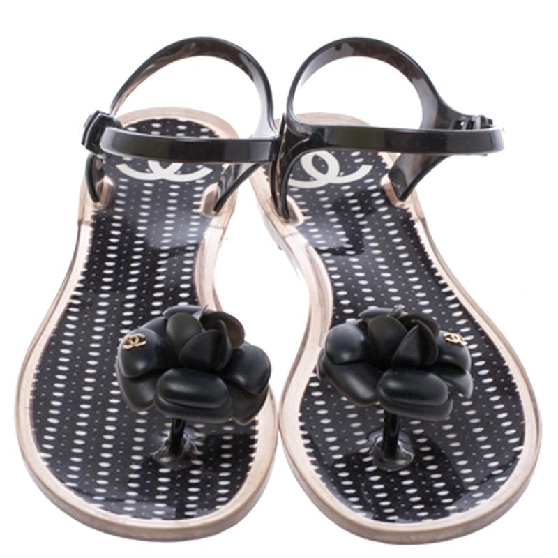 These Chanel sandals are stunning and are crafted exquisitely from jelly. They come in a classic black color and are perfect for everyday style. They feature the signature Camellia flower with the CC logo on the toes and have buckle adjustable ankle