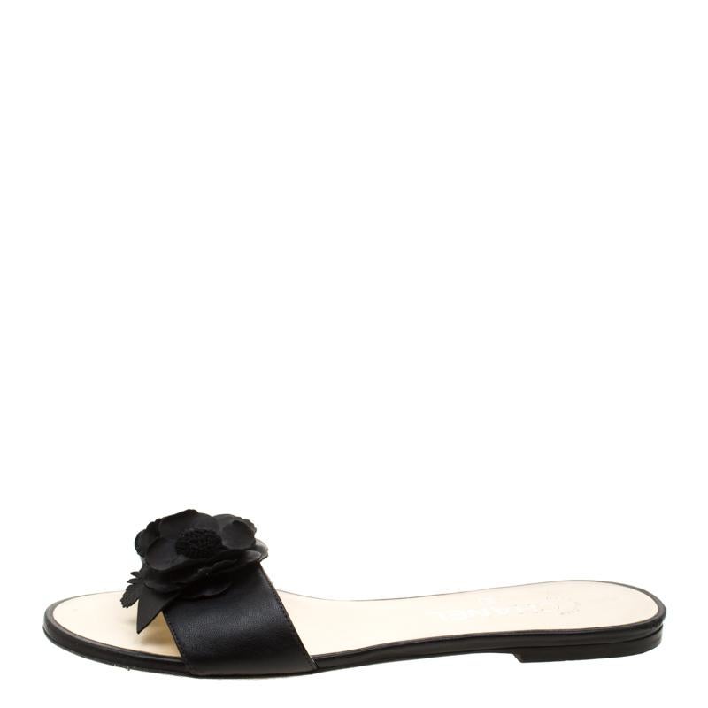 Put your best foot forward this summer in these pretty Chanel slides. Crafted from leather in Italy, they feature a Camellia-embellished vamp strap and a leather-lined interior with the brand's label. These black flats are sure to attract