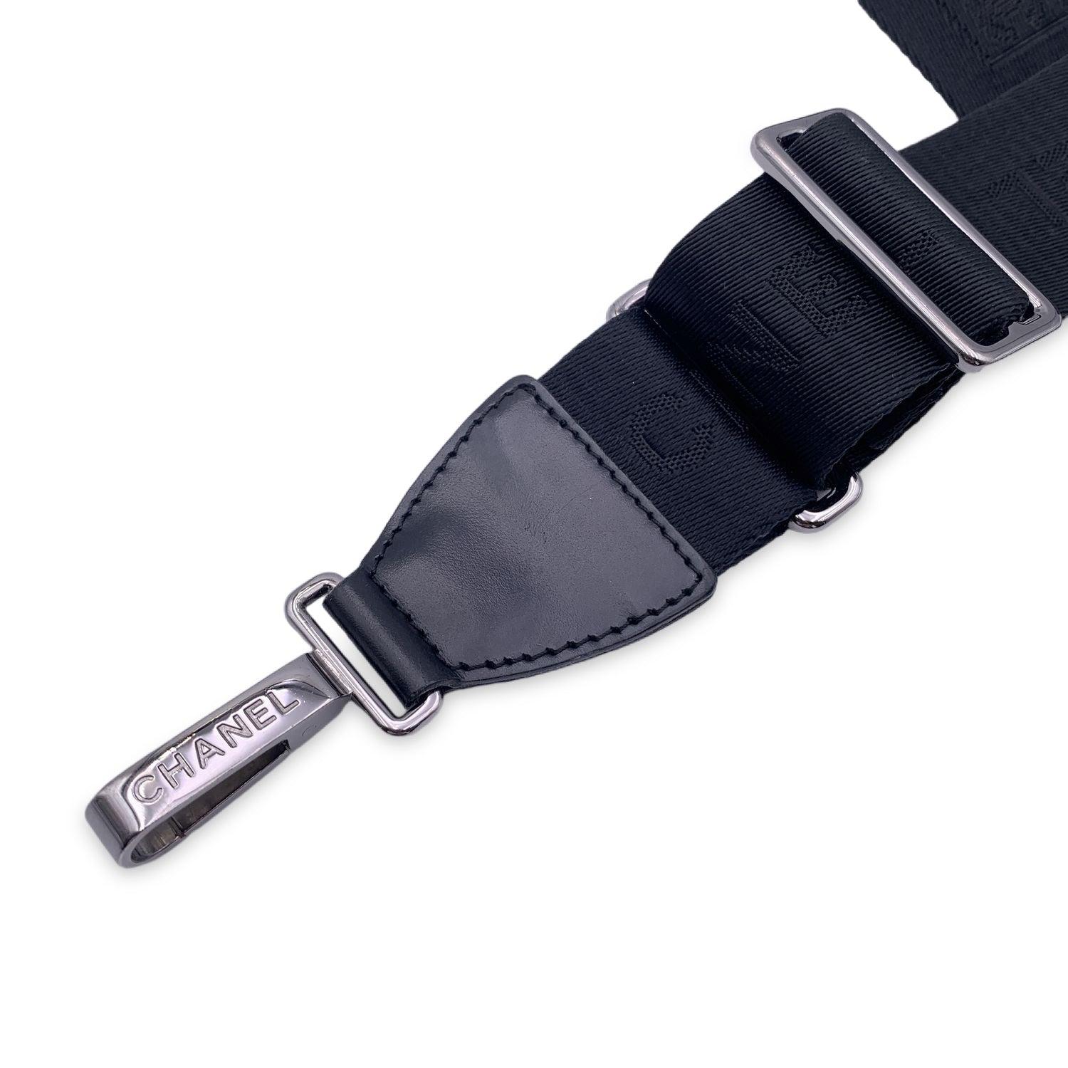 Chanel black nylon adjustable shoulder strap. CC logos and Chanel signatures on the strap and silver metal hardware. Can be attached to any bag on the shoulder or across the body. It can even be used for larger travel bags. Total lenght: 54 inches