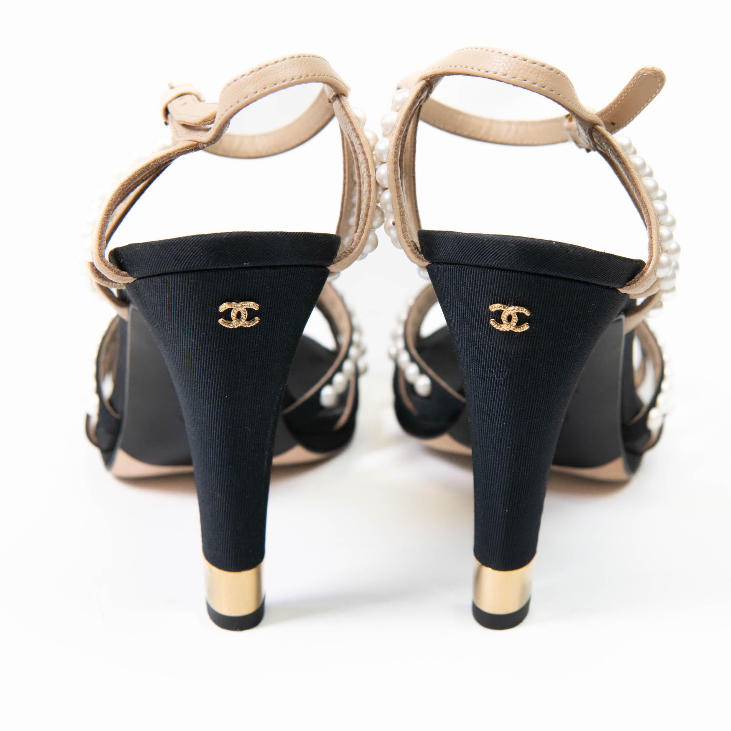 100% Authentic 

These canvas/leather sandals are feminine and fashionable. Lined with strong and durable leather, they are perfect for any season. These ankle strap sandals from Chanel feature faux pearls to lend the look of elegance to your