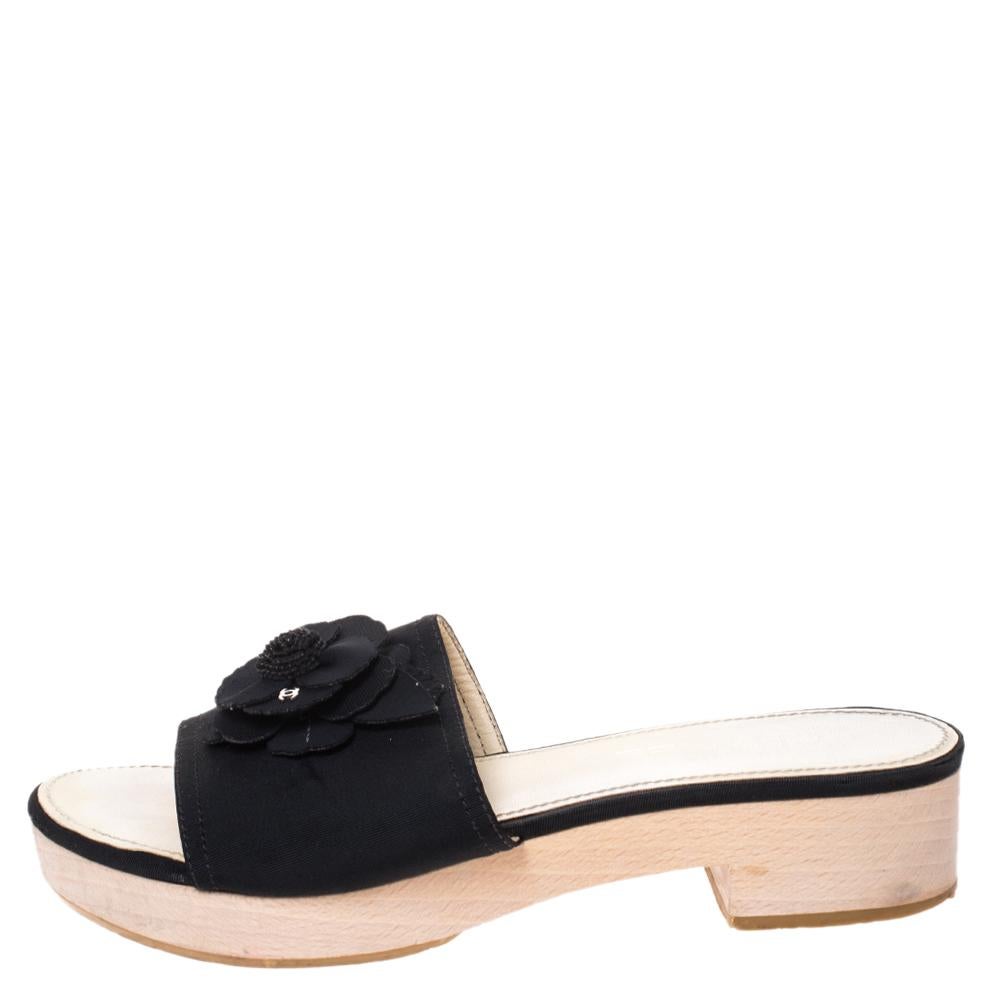 These sandals from the house of Chanel are a fine blend of comfort and class. They are designed from luxurious canvas for maximum comfort and come in a classic black color. They are adorned with the signature camellia flower on the uppers and also