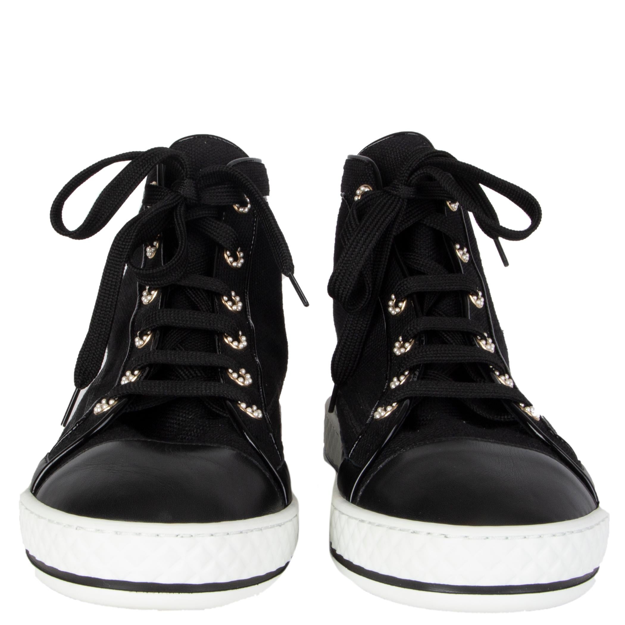 100% authentic Chanel high-top sneakers in black canvas and calfskin featuring pearl eyelets and a white rubber sole. Brand new. Come with dust bag. 

Measurements
Imprinted Size	40
Shoe Size	40
Inside Sole	26cm (10.1in)
Width	8cm