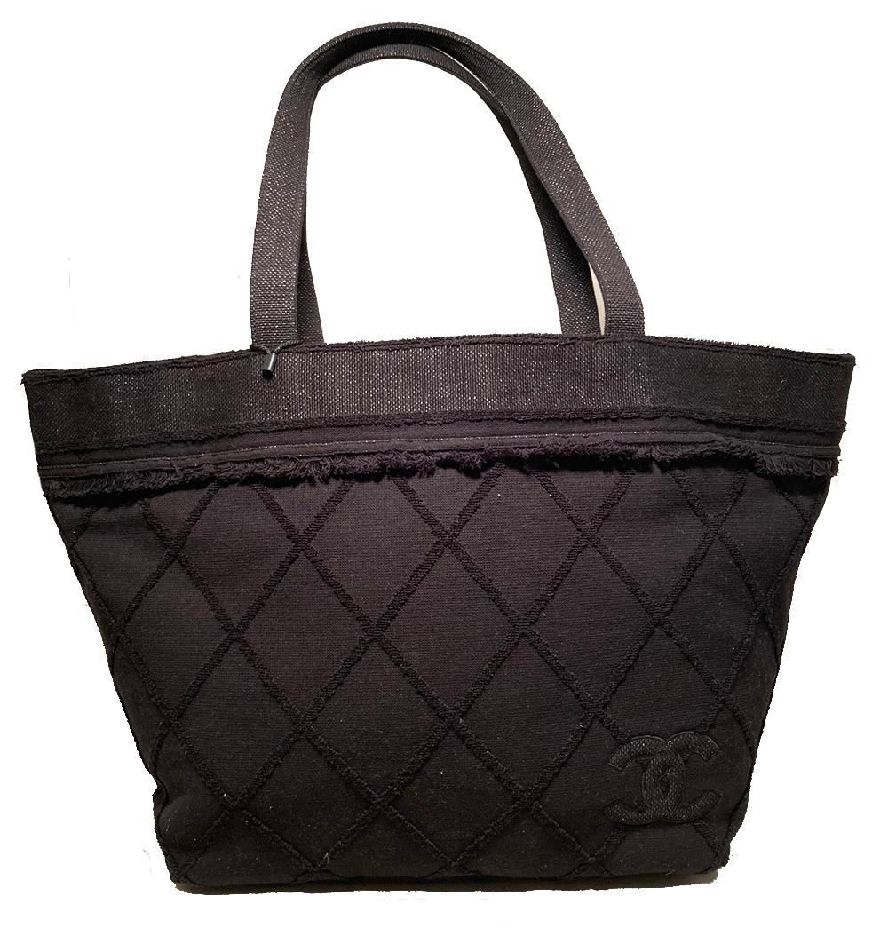 Chanel Black Canvas Raw Edge Tote Bag in excellent condition. Black woven canvas exterior with raw fringe edge canvas quilted pattern throughout. CC logo quilted in canvas on bottom right corner of both front and back sides. Top edge and double