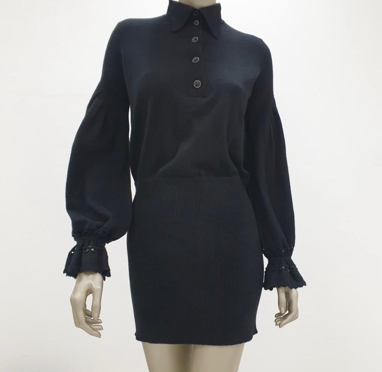 Chanel Black Cashmere Knit Textured Ribbed 2007 Keyhole Cocktail Dress

100% cashmere knit dress . 
Classic collar. 
Button down. 
Keyhole logo buttons.
 Ruched sleeve with eyelet crochet detail.
Above the knee length. T
extured ribbed knit skirt.