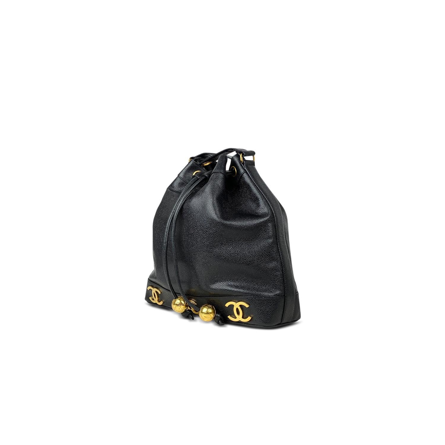 Black Caviar leather Chanel bucket bag with

- Gold-tone hardware
- Dual chain-link and leather shoulder strap
- CC logo adornments at exterior
- Tonal leather interior and drawstring closure at front flap featuring round logo adornments

Overall
