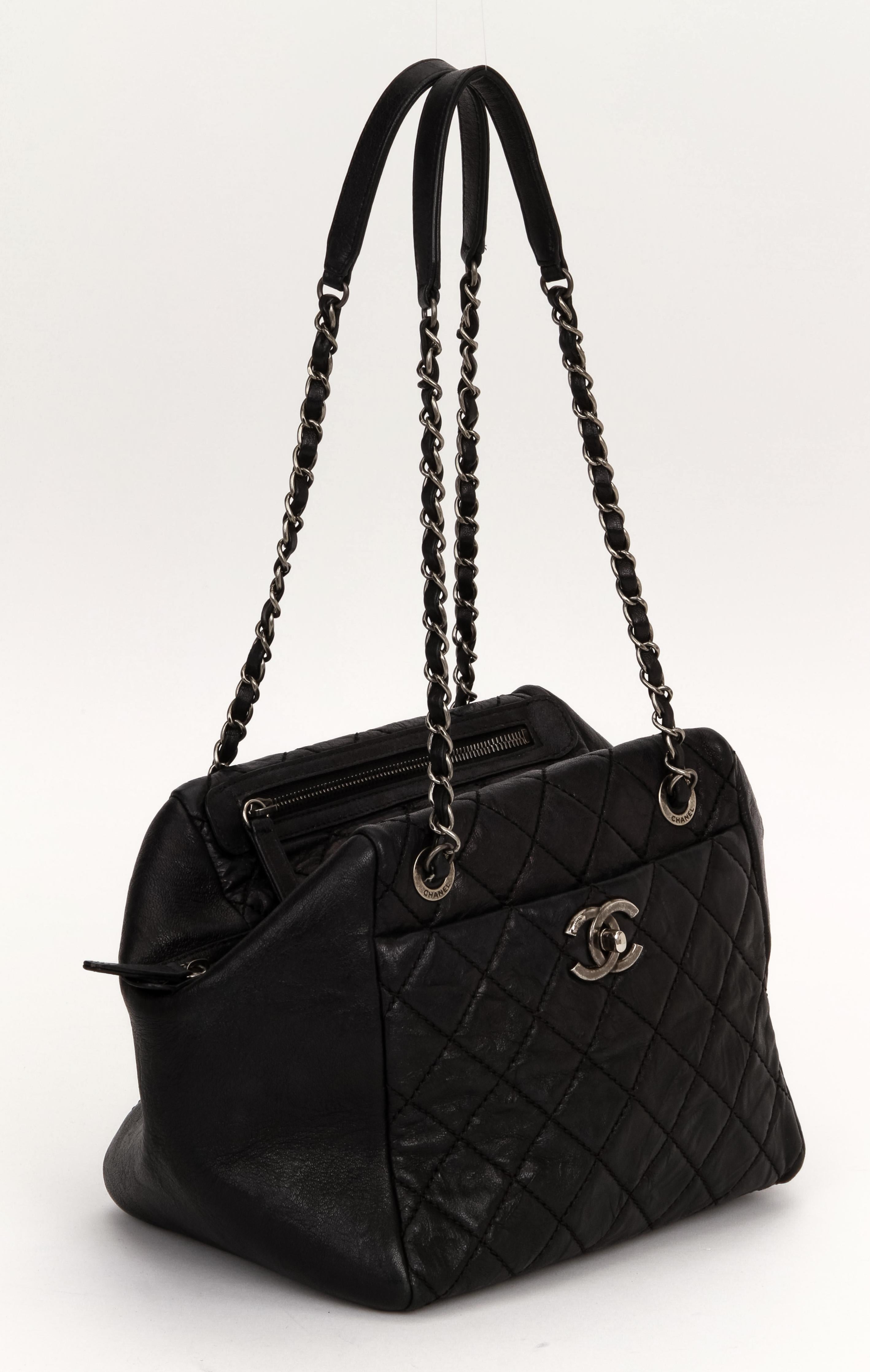 Chanel black caviar shoulder bag with two top zippers, one pocket and one center compartment. Plastic still on interior zipper pull. Ruthenium hardware. Shoulder drop 9