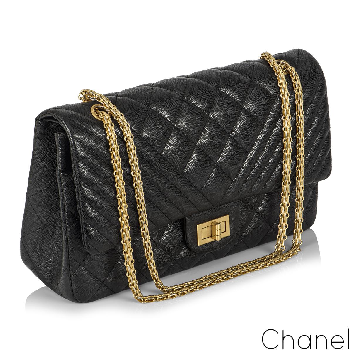 A Chic Chanel 2.55 Reissue Jumbo Double Flap Handbag. The exterior of this reissue 2.55 is crafted in classic black caviar leather with aged gold tone hardware. This reissue bag features both signature diamond and chevron style stitching, which is