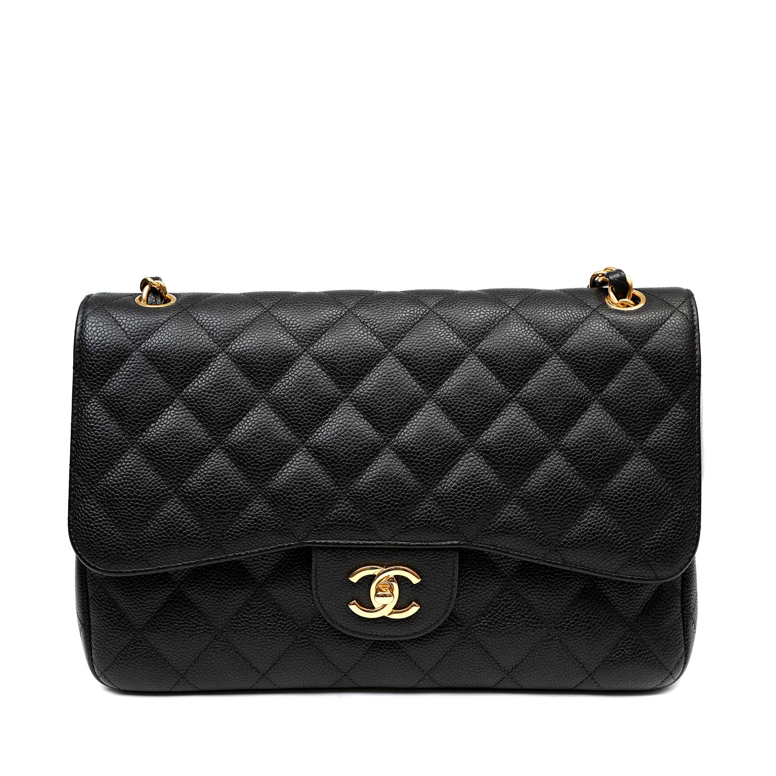 This authentic Chanel Black Caviar Jumbo Classic Flap Bag is in pristine unworn condition.  A key piece in any sophisticated wardrobe, the Jumbo Classic in black caviar with gold hardware is one of the most sought-after Chanel styles