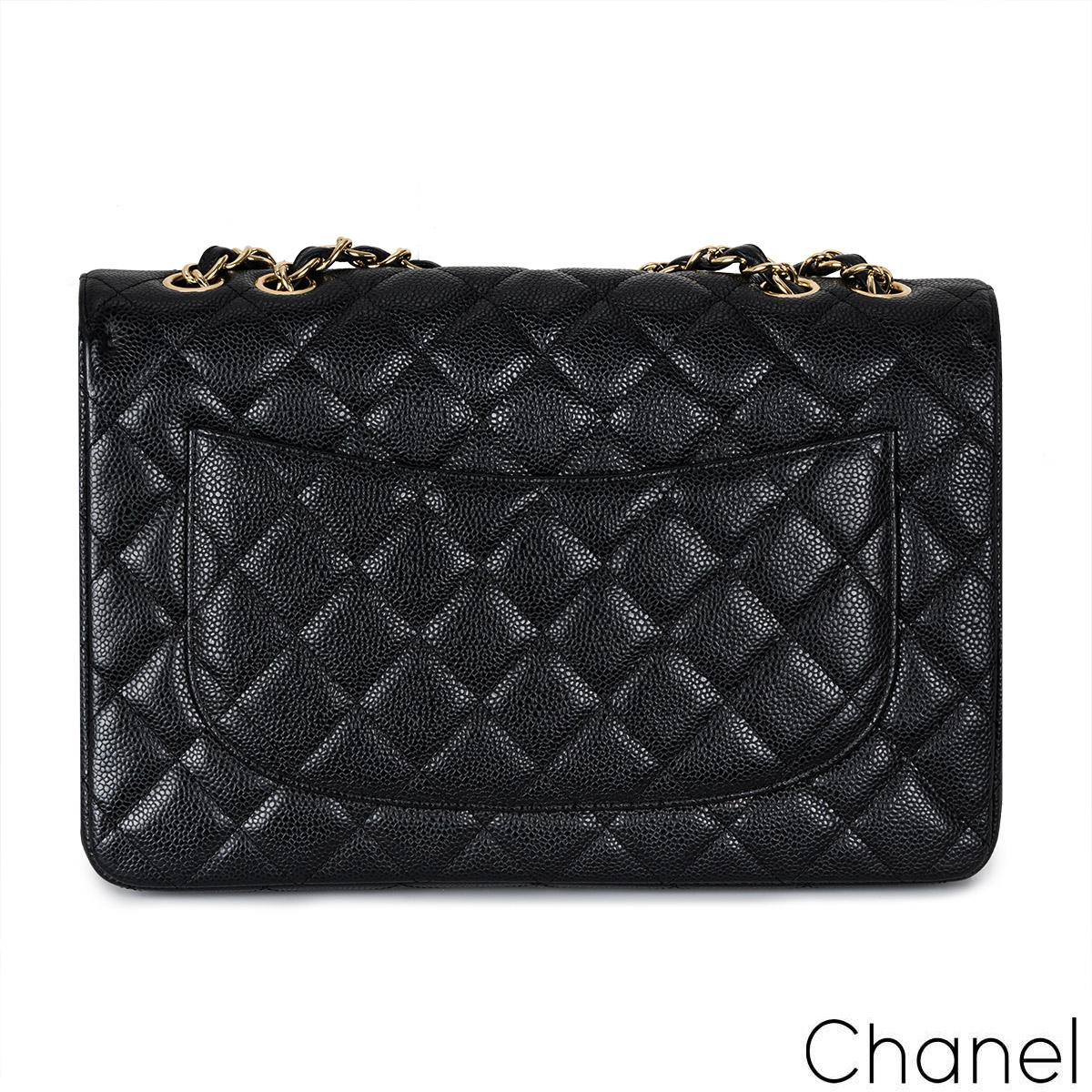 A classic Chanel Jumbo Classic Single Flap Handbag. The exterior of this jumbo classic is crafted in black caviar quilted leather with gold-tone hardware. It features a front flap with signature CC turnlock closure, half moon back pocket, and an