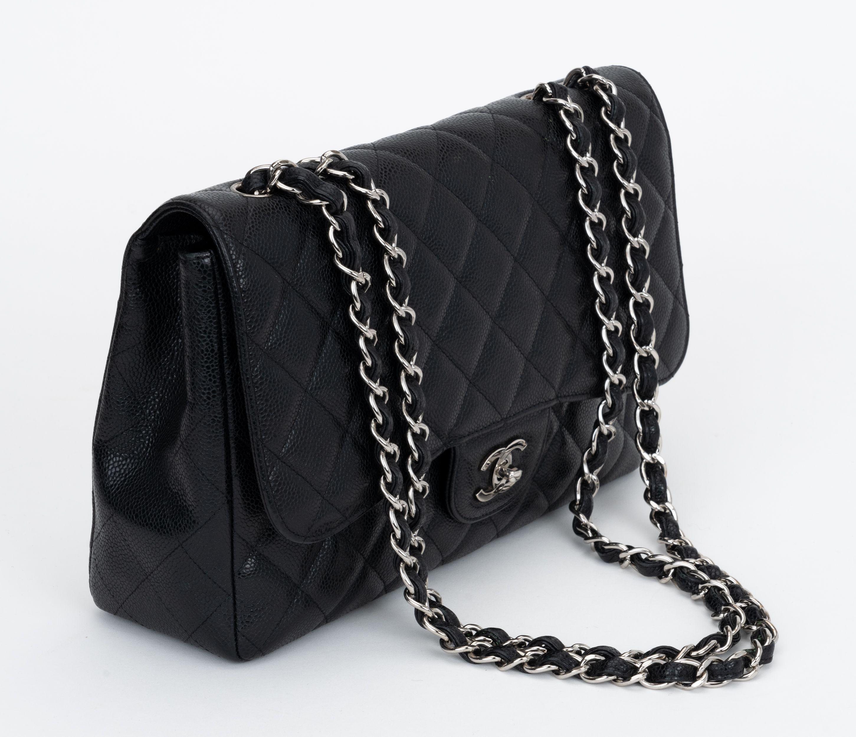 Chanel black caviar leather quilted jumbo single-flap bag.  Silver tone hardware. Shoulder drop, 14