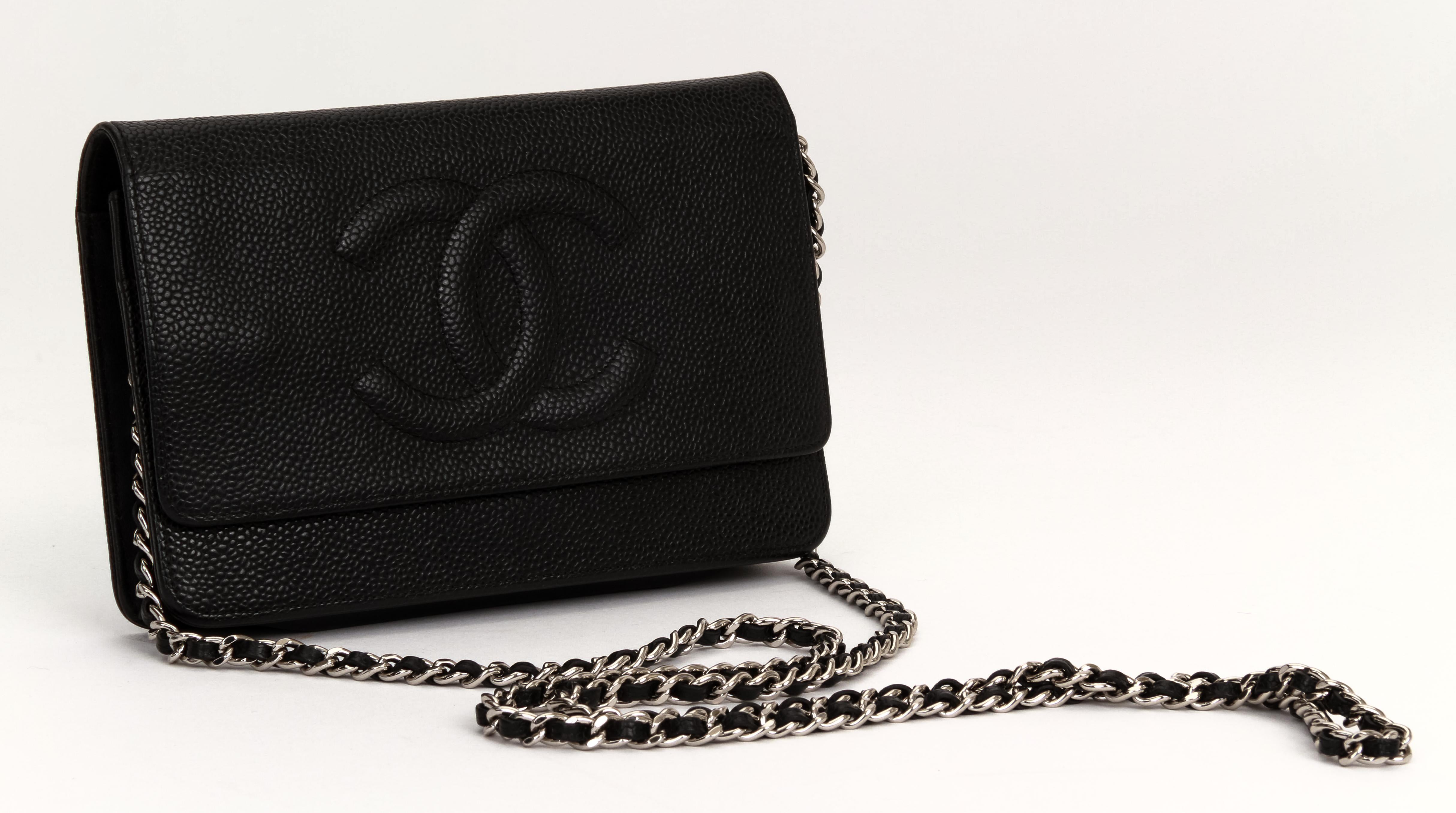 Chanel black caviar leather cross-body wallet on a chain with lambskin sides. Silver hardware. Collection 19, 2014. Comes with hologram and original dust cover . Minor inside wear.