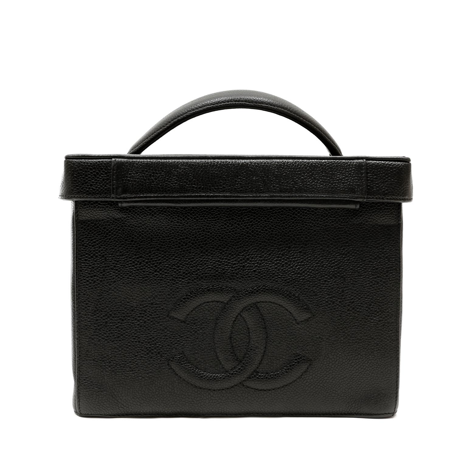 This authentic Chanel Black Caviar Large Vanity Case is a vintage piece in good condition from the mid 1990's.   Durable black textured caviar leather with gold tone interlocking CC twist lock.  Hinged top with interior mirror. Interior side