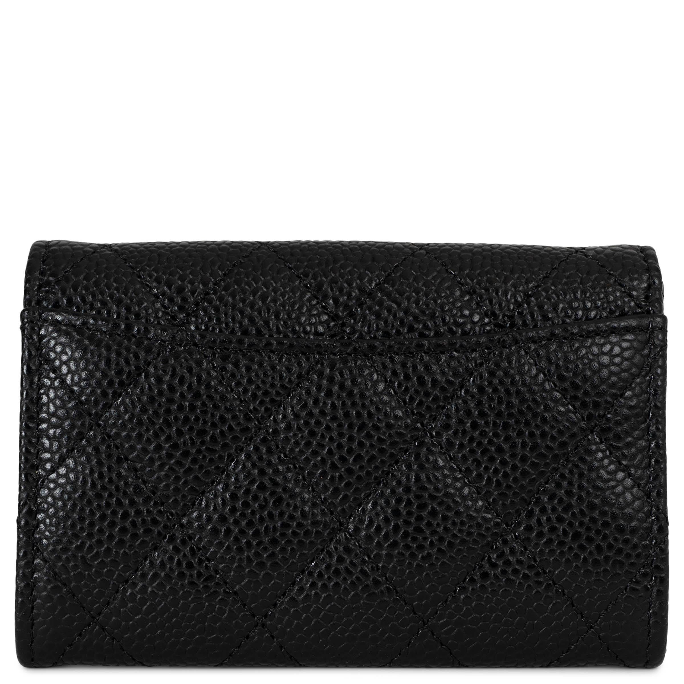 This 100% authentic Chanel Classic card wallet in black Caviar leather with a silver-tone CC is a timeless essential. Crafted for durability and elegance, it features a compact silhouette that closes with a press-button. The interior is lined in