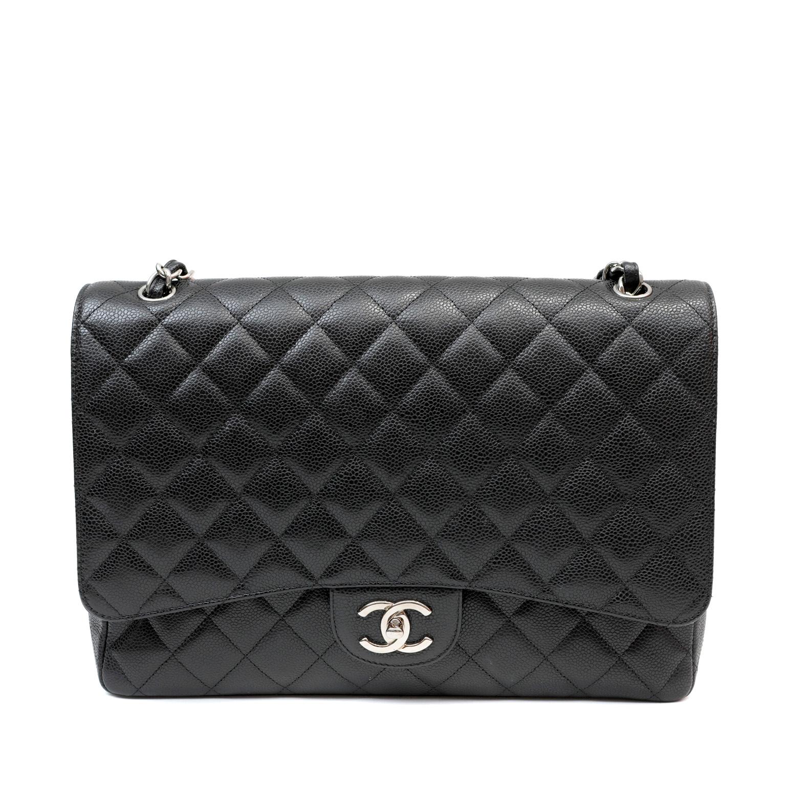 This authentic Chanel Black Caviar Leather Double Flap Maxi is in pristine condition. Paired with silver hardware, the Maxi silhouette is an extremely sought-after classic. Durable and textured black caviar leather is quilted in signature Chanel