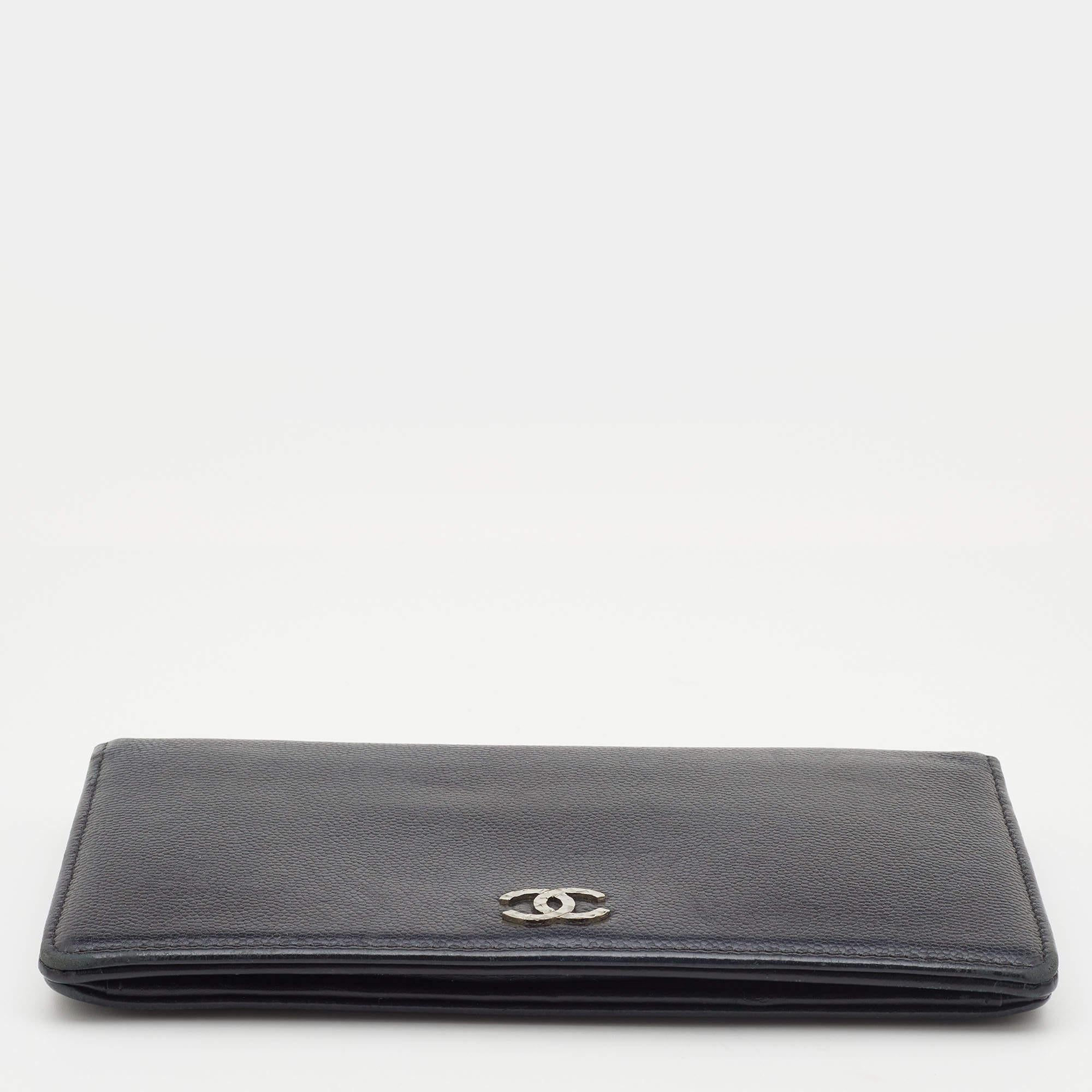 This Yen wallet from Chanel is a wonderful creation! This black wallet is crafted from Caviar leather and features the CC logo on the front. This classy piece opens to a leather and fabric interior that houses multiple card slots and open