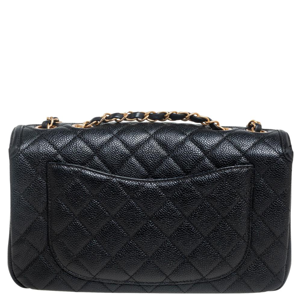 We are in utter awe of this flap bag from Chanel as it is appealing in a surreal way. Exquisitely crafted from black caviar leather, it bears the signature label on the leather interior and the iconic CC logo on the front flap. The piece has