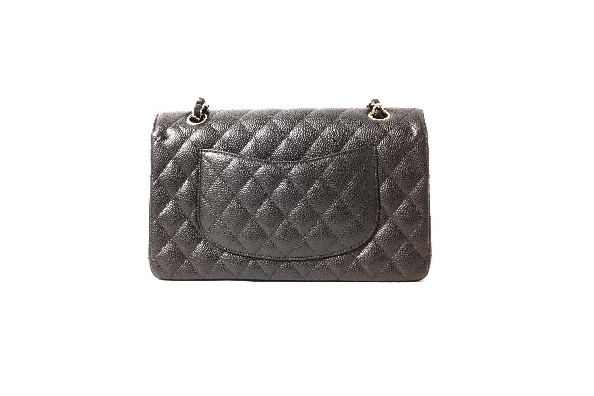This authentic Chanel Black Caviar Medium Classic is in mint condition. Part off the Timeless Classics Collection, the medium double flap is a must have for any wardrobe.
Durable caviar leather is textured and scratch resistant.  Gold interlocking
