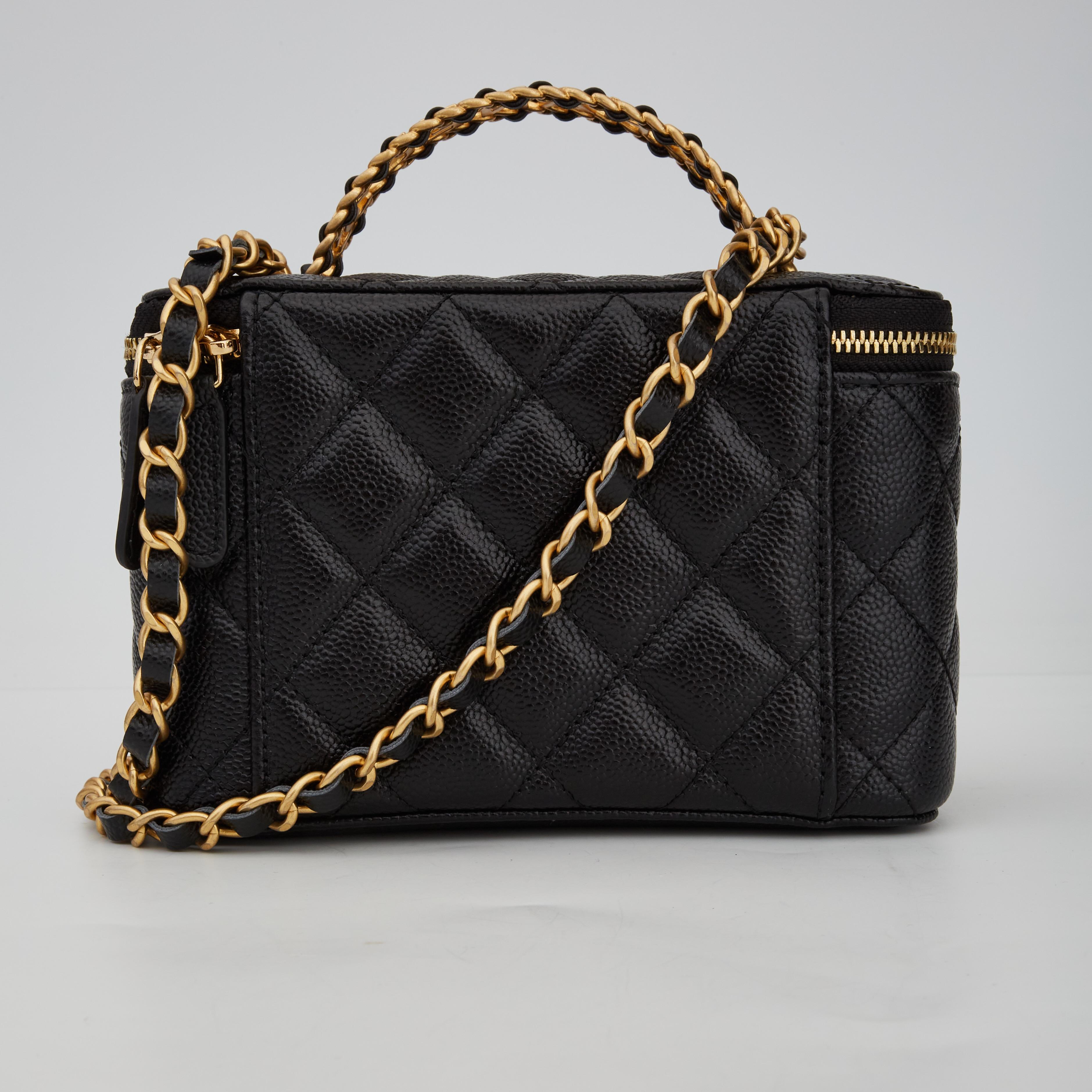 This shoulder bag is made of luxurious grained calfskin leather. The bag features a gold-toned chain interlaced with leather shoulder strap, a Chanel CC logo on the front, top zip closure, a unique top handle with CC logos with interlaced leather