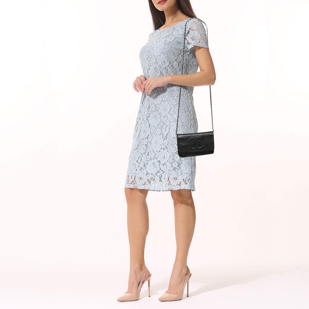 Crafted from durable saffiano leather  this Chanel WOC bag comes in a classy black. Its structured design includes a flap closure  keeping your essentials secure  while the strap offers hands free convenience.