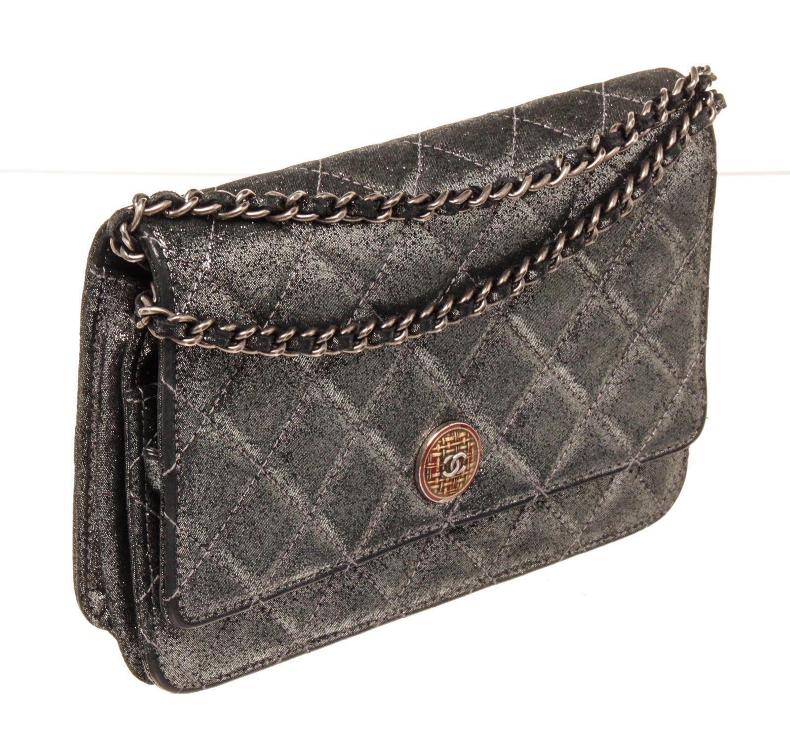 Chanel Black Caviar Leather WOC Chain Bag with caviar leather, silver-tone hardware, single chain-link and leather shoulder strap, single exterior patch pocket at back, dual pockets at flap underside; one with zip closure, tonal leather lining, dual